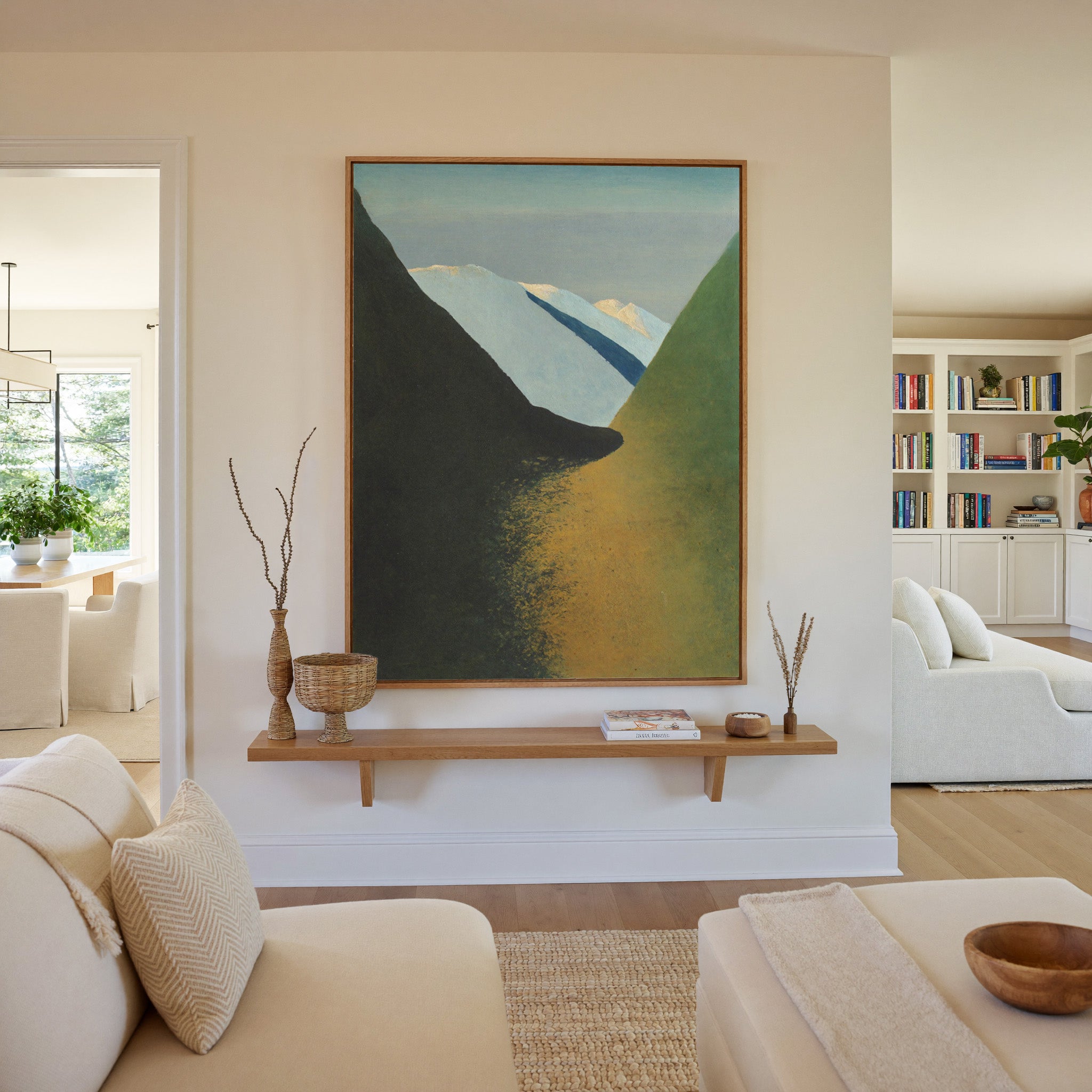 dark foreground slopes with pale blue peaks and canvas wall art in an oak frame in a living room