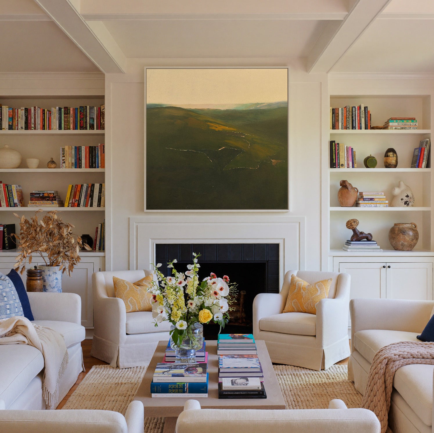 green valley landscape with a winding river and canvas wall art in a white frame above a fireplace