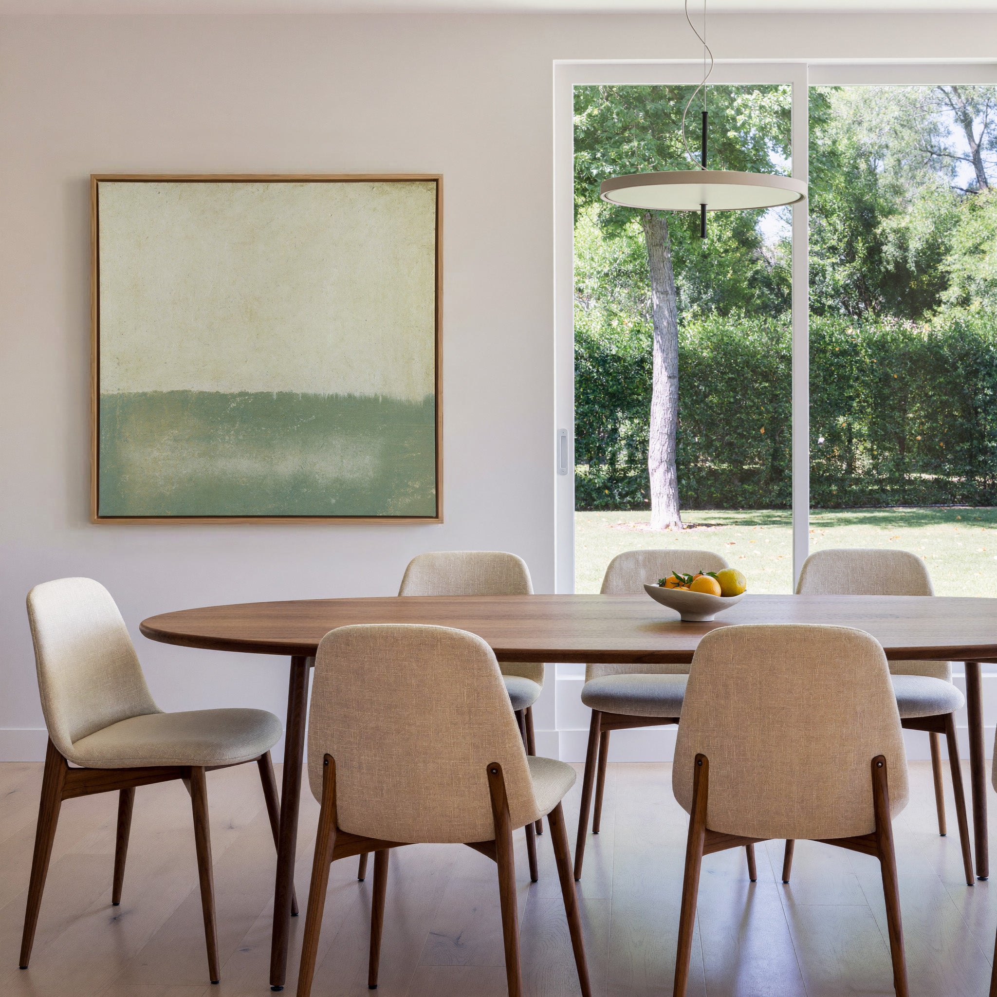 soft sage and cream abstract with a low canvas wall art in an oak frame in a dining room