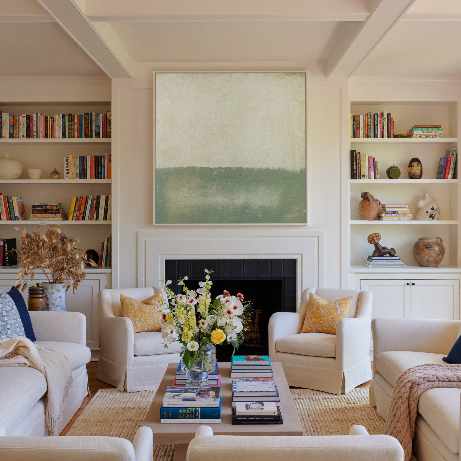 soft sage and cream abstract with a low canvas wall art in a white frame above a fireplace