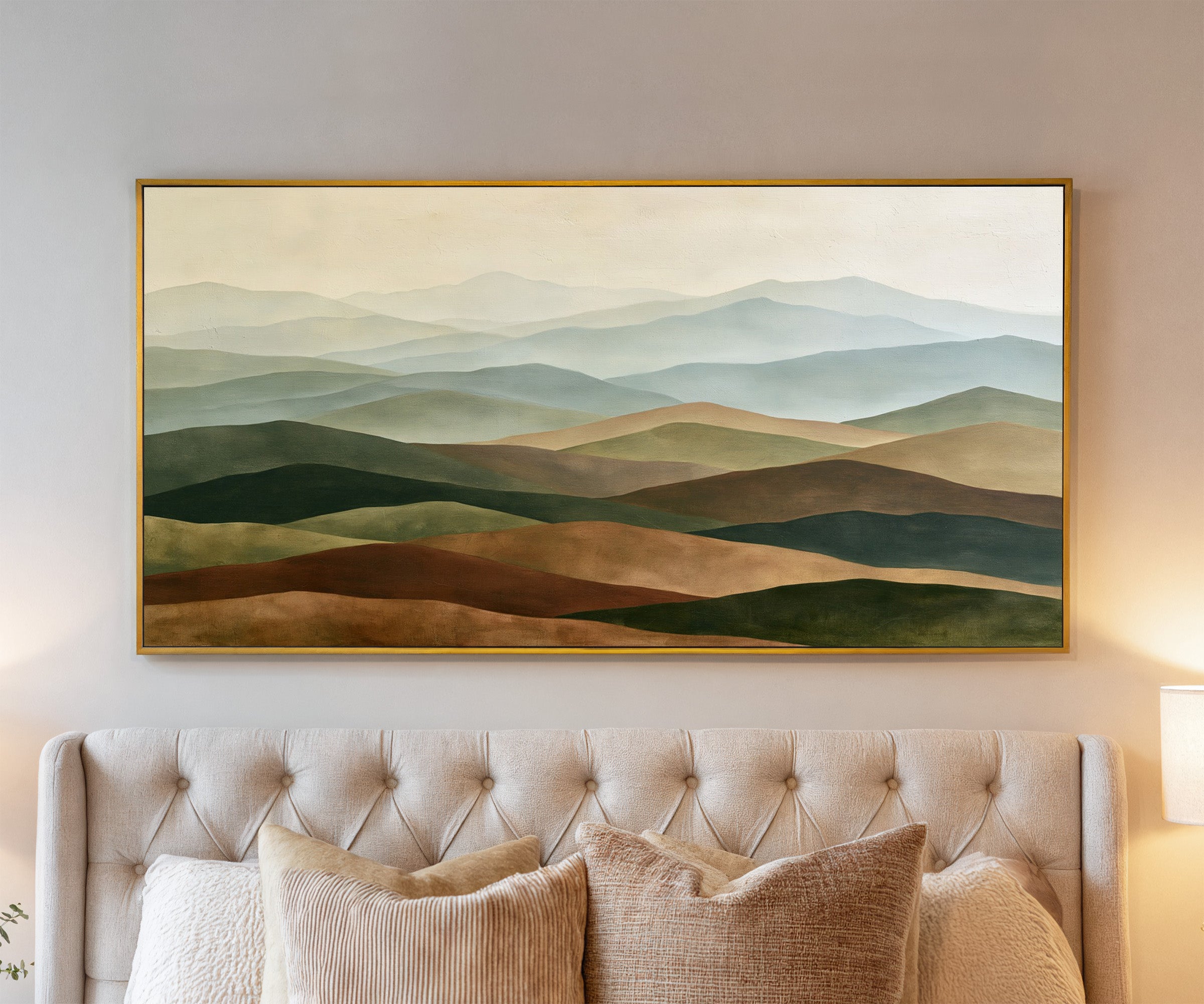 layered rolling hills in sage, blue gray, tan, canvas wall art in a gold frame above a bed
