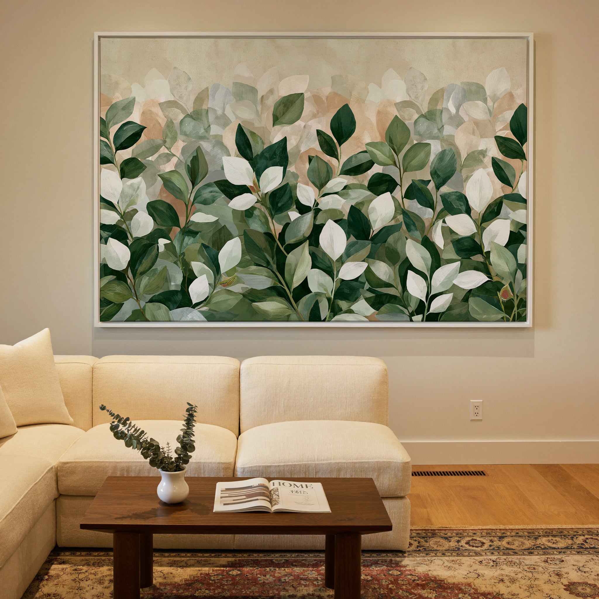 overlapping green and cream leaves canvas wall art in a white frame in a styled room setting