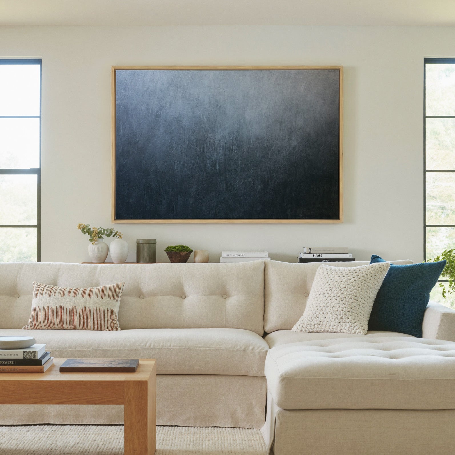 cool blue gray abstract with soft vertical canvas wall art in a natural wood frame in a living room