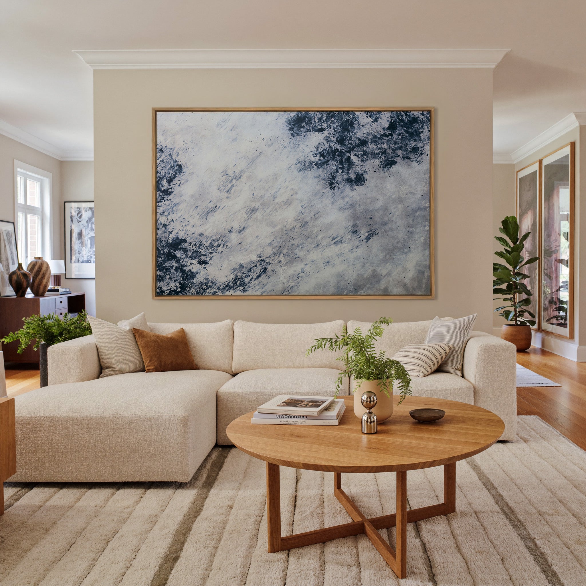 soft black and blue abstract with scattered canvas wall art in an oak frame in a living room
