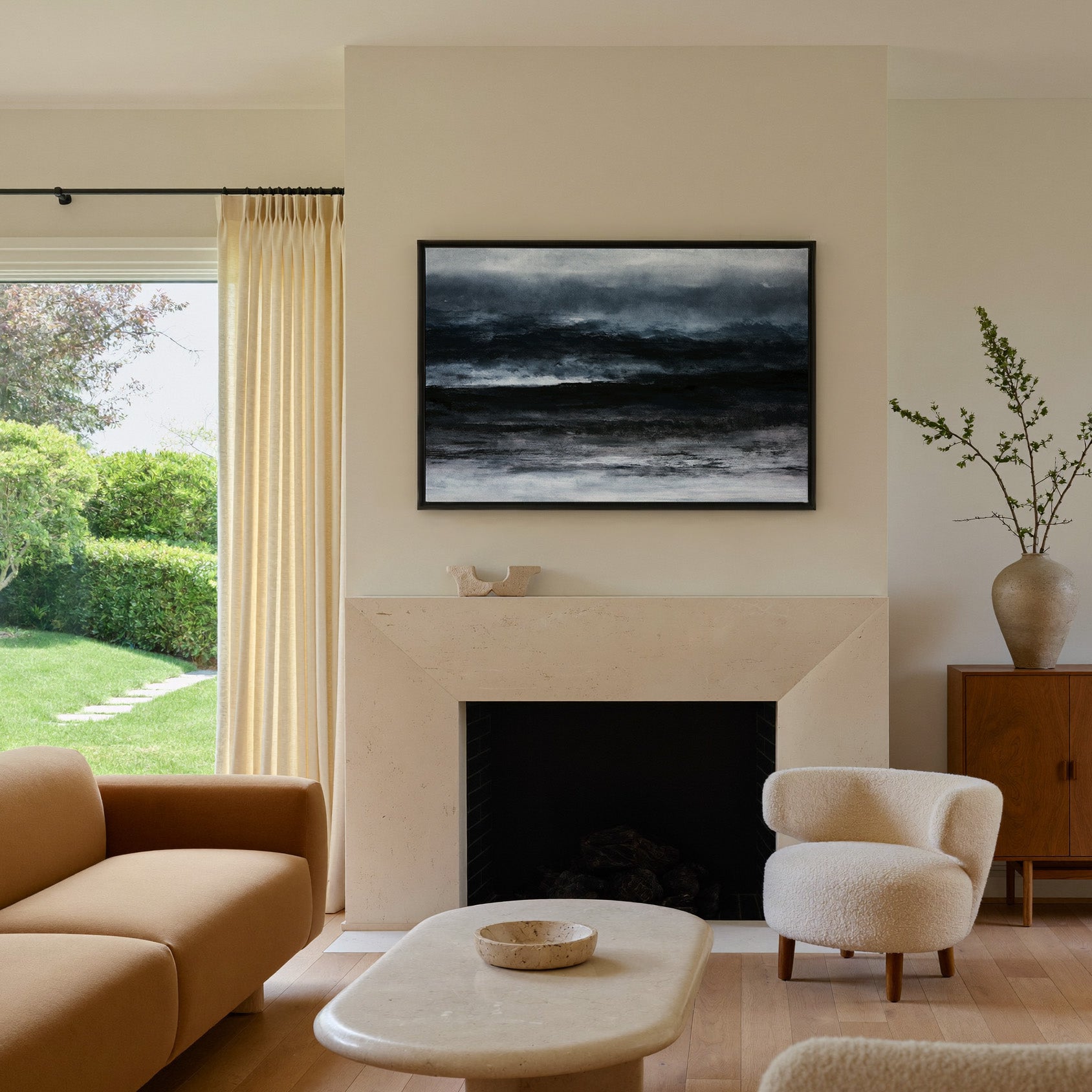 dark black and navy abstract with layered canvas wall art in a black frame above a mantel