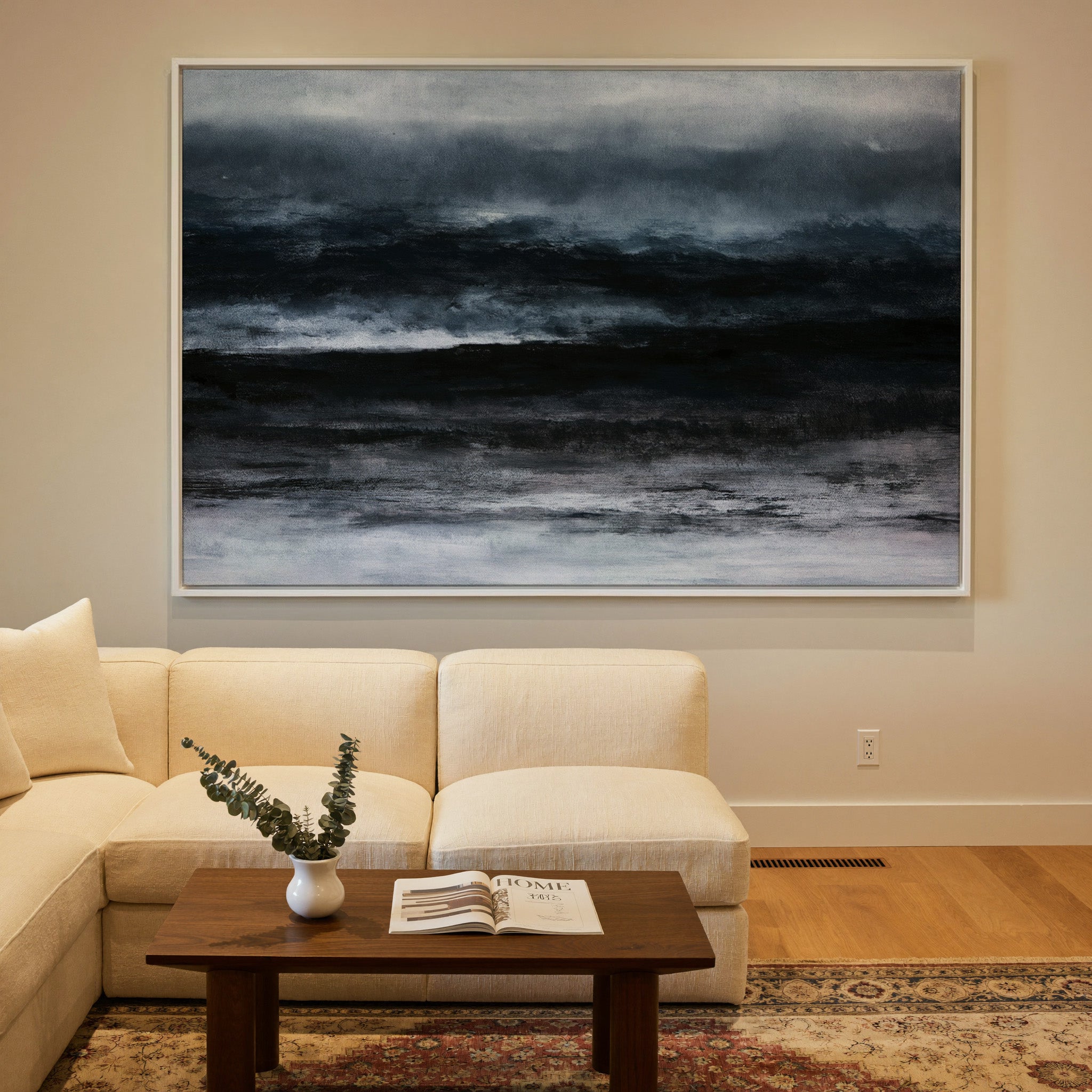 dark black and navy abstract with layered canvas wall art in a white frame in a styled room setting