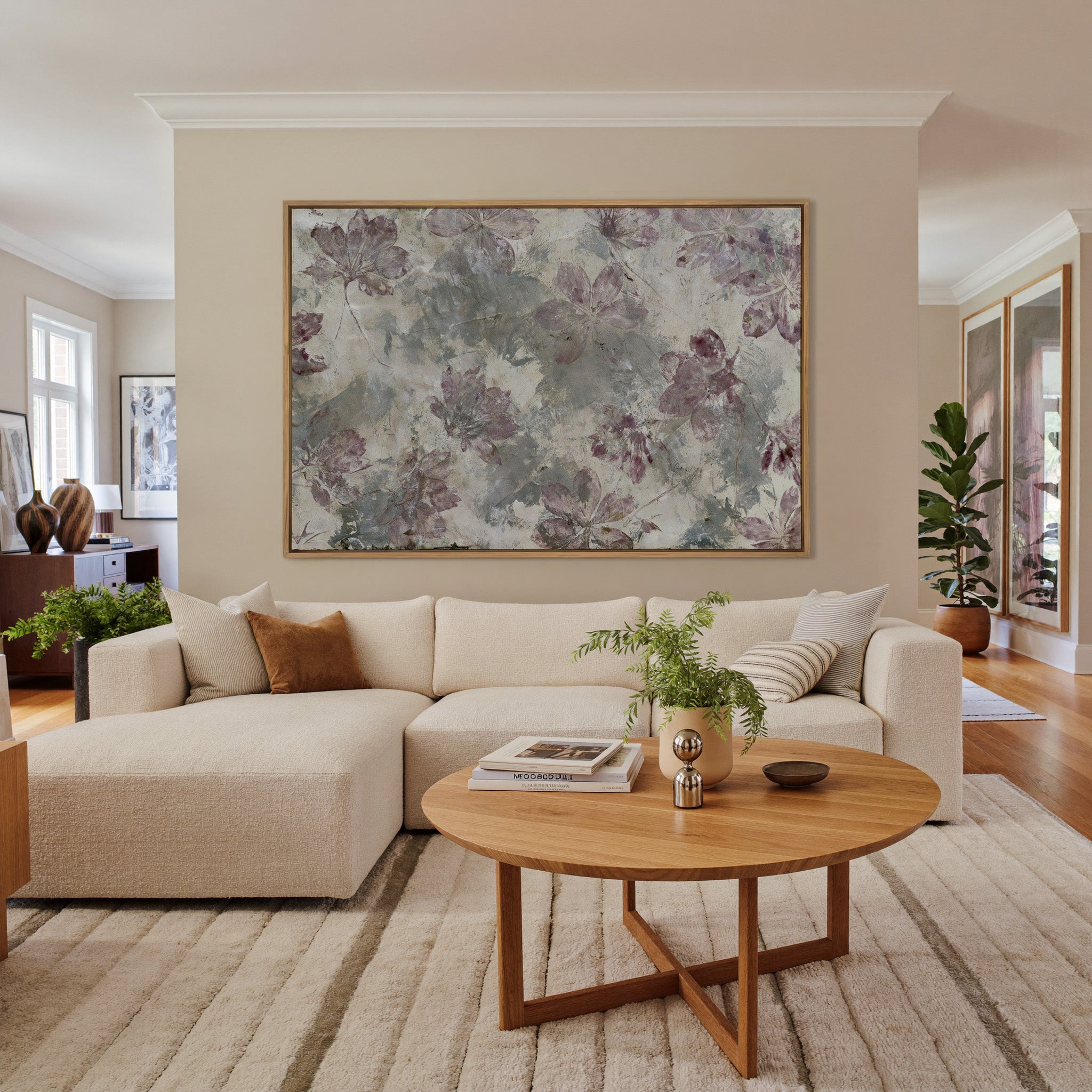 muted floral abstract with mauve blossoms on a canvas wall art in an oak frame in a living room