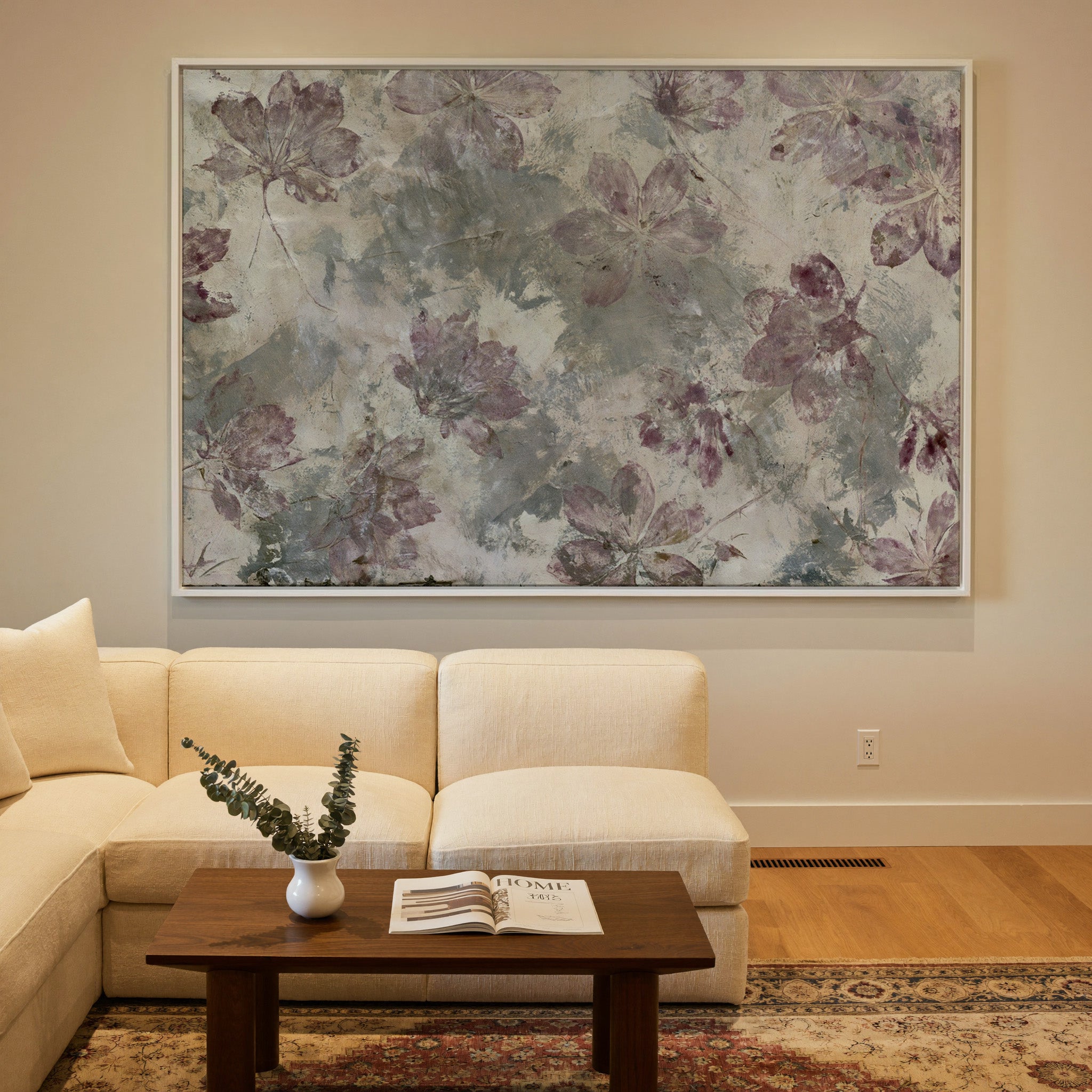 muted floral abstract with mauve blossoms on a canvas wall art in a white frame in a styled room setting