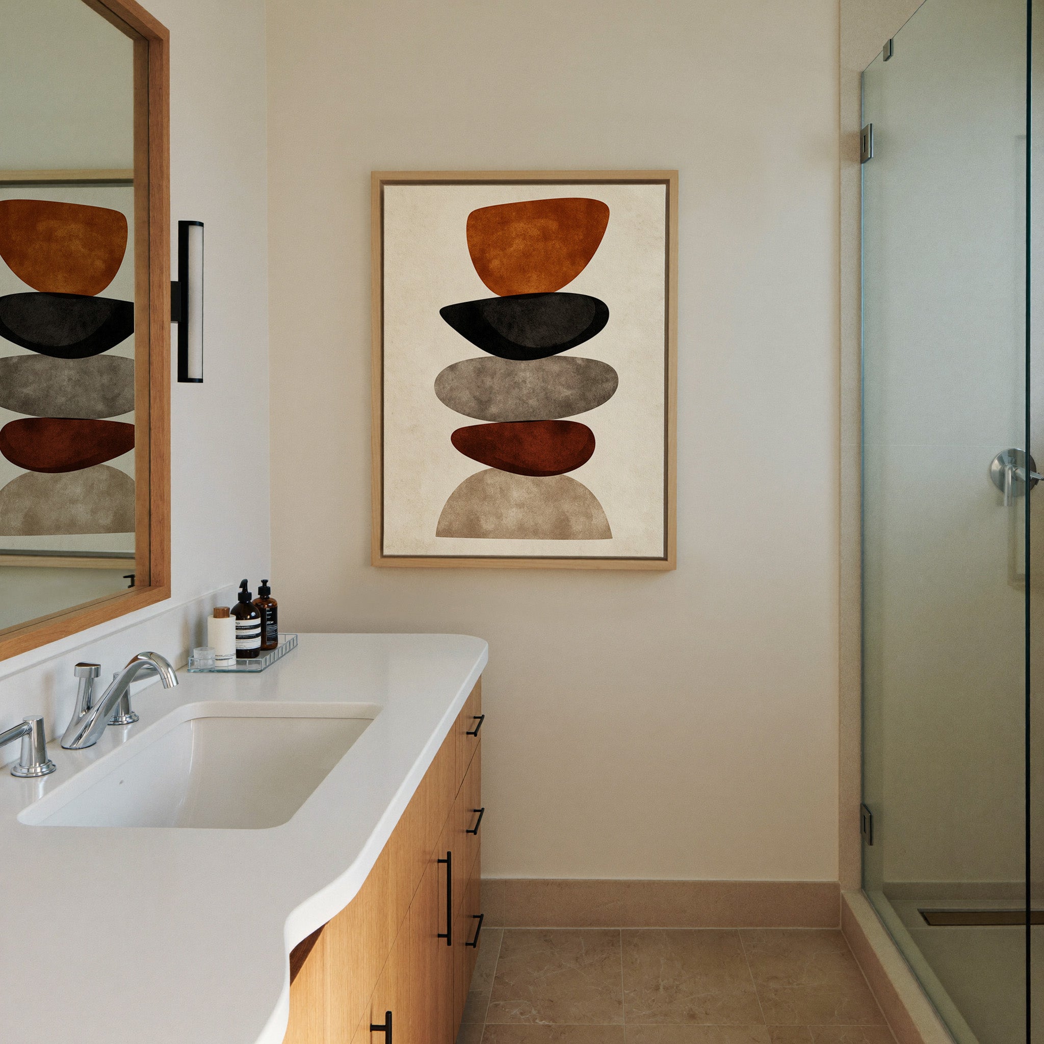 stacked organic shapes in rust, black, taupe, canvas wall art in a natural wood frame in a styled room setting
