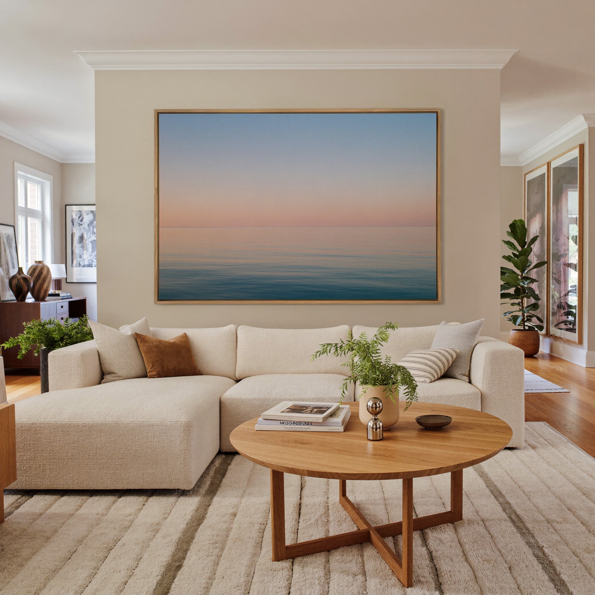 soft pastel sea and sky seascape canvas wall art in an oak frame in a living room