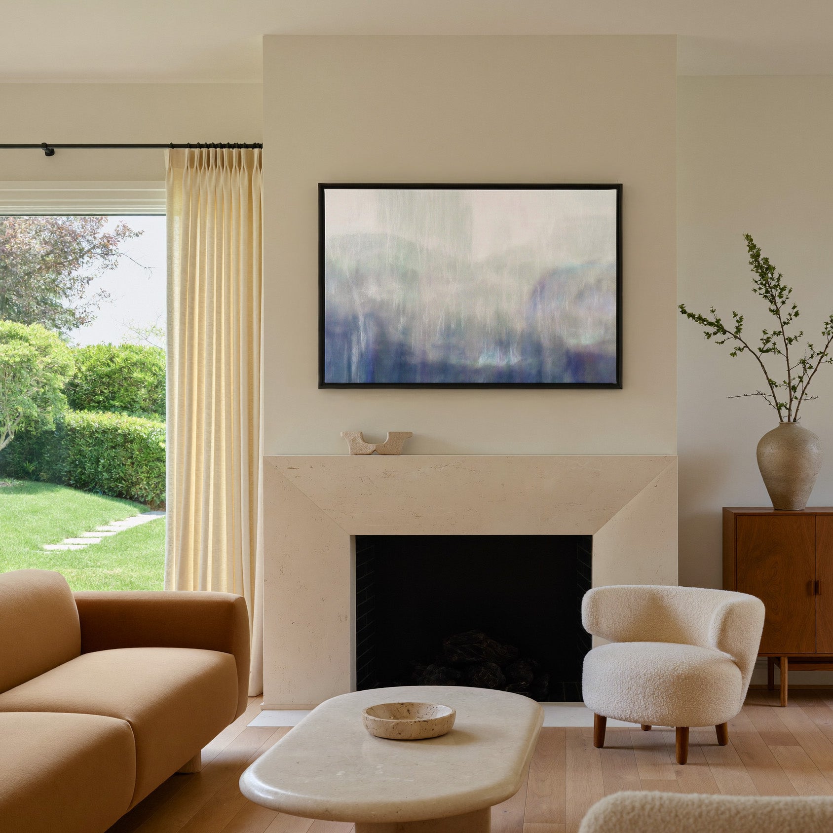 soft blue and violet abstract canvas wall art in a black frame above a mantel