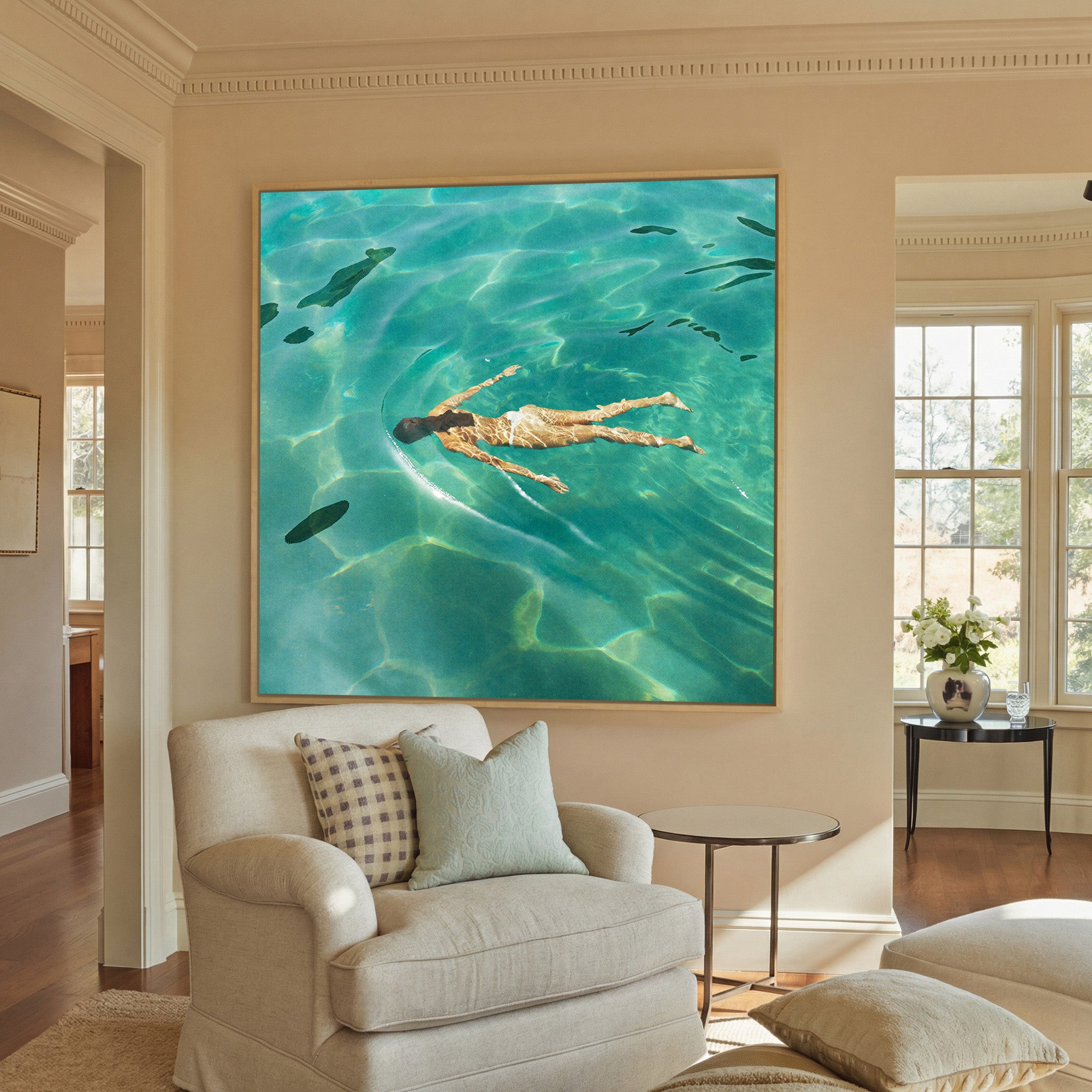 overhead swimmer in turquoise water canvas wall art in a natural wood frame in a styled room setting