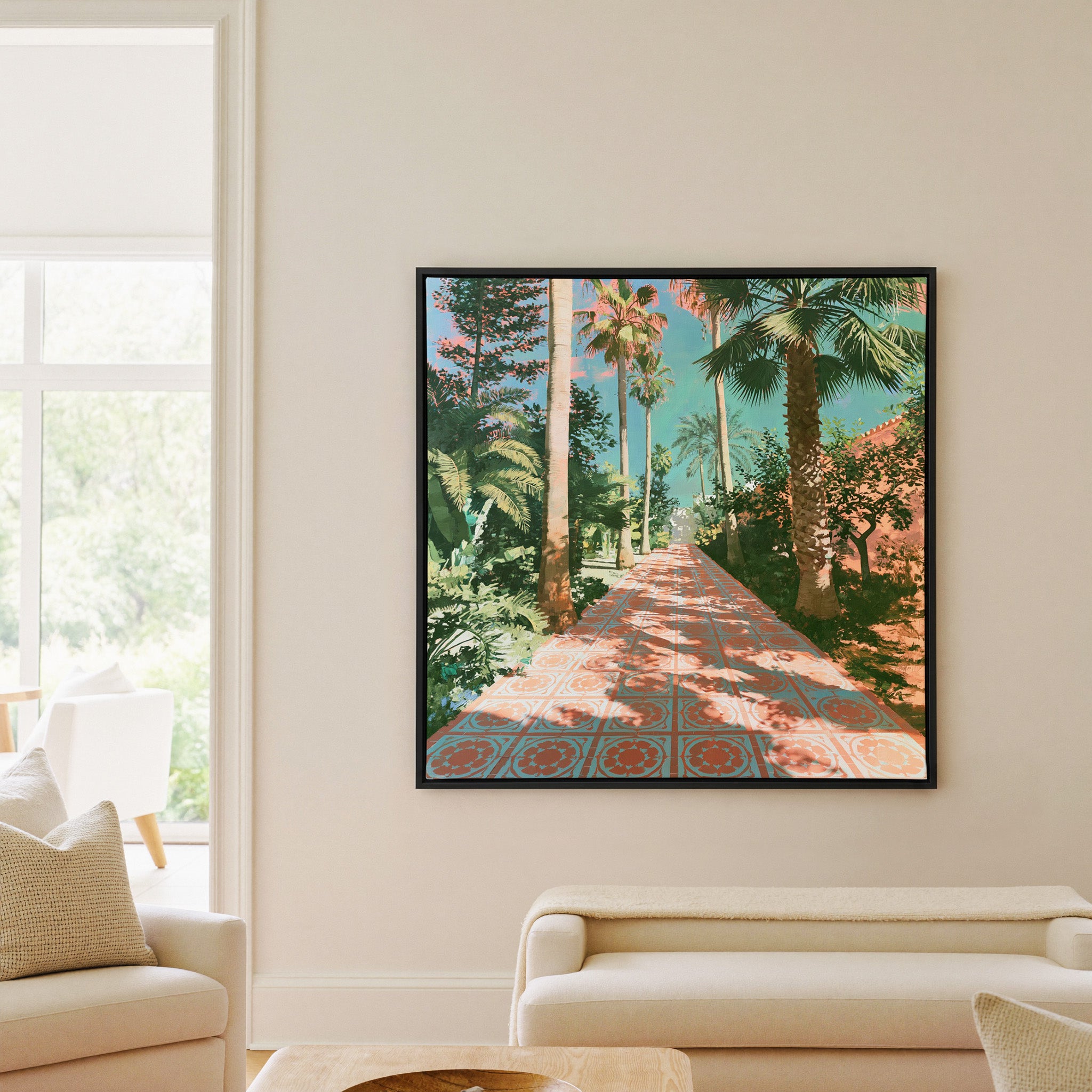 tall palms and patterned terracotta paving canvas wall art in a black frame in a living room