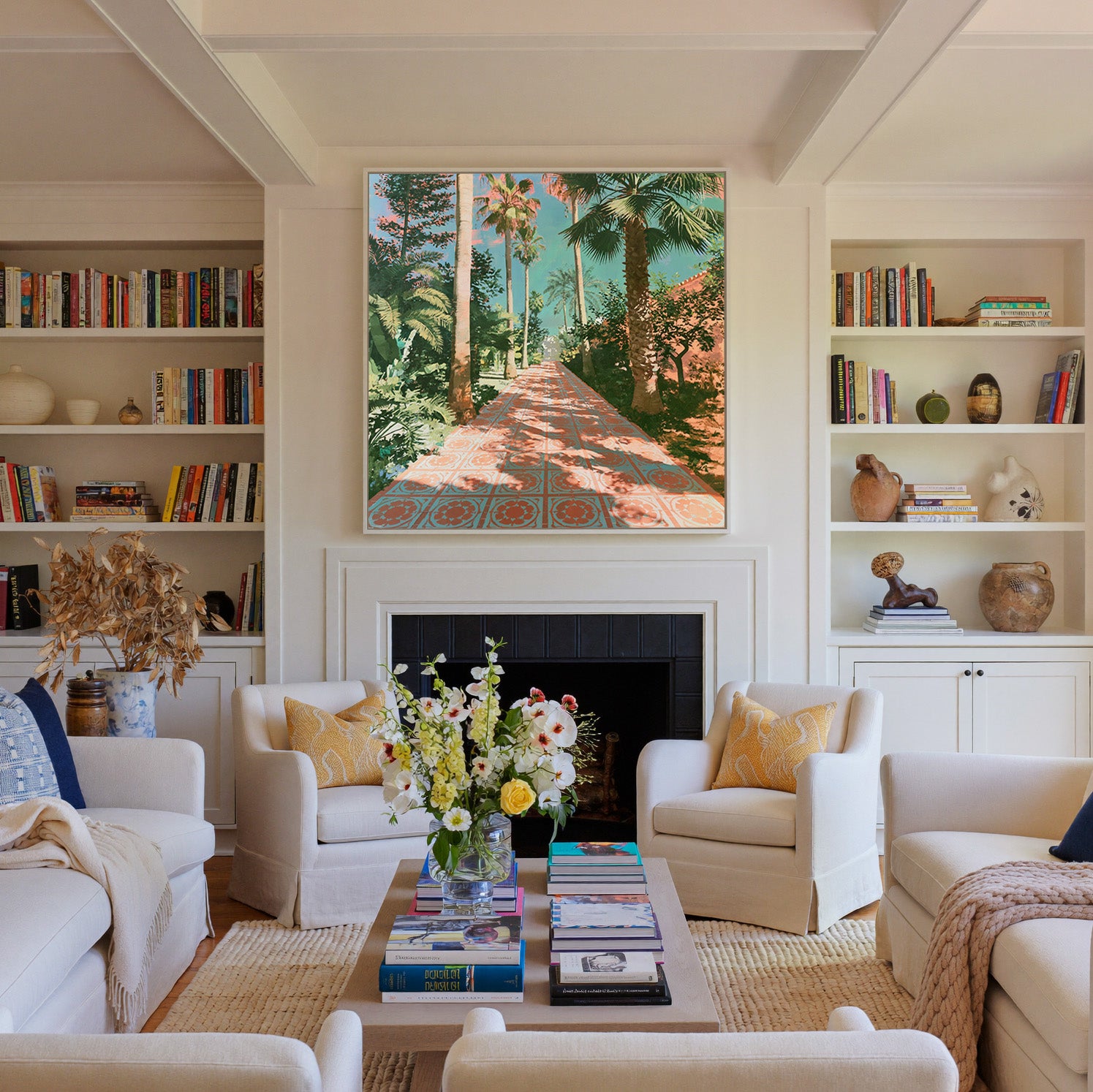 tall palms and patterned terracotta paving canvas wall art in a white frame above a fireplace