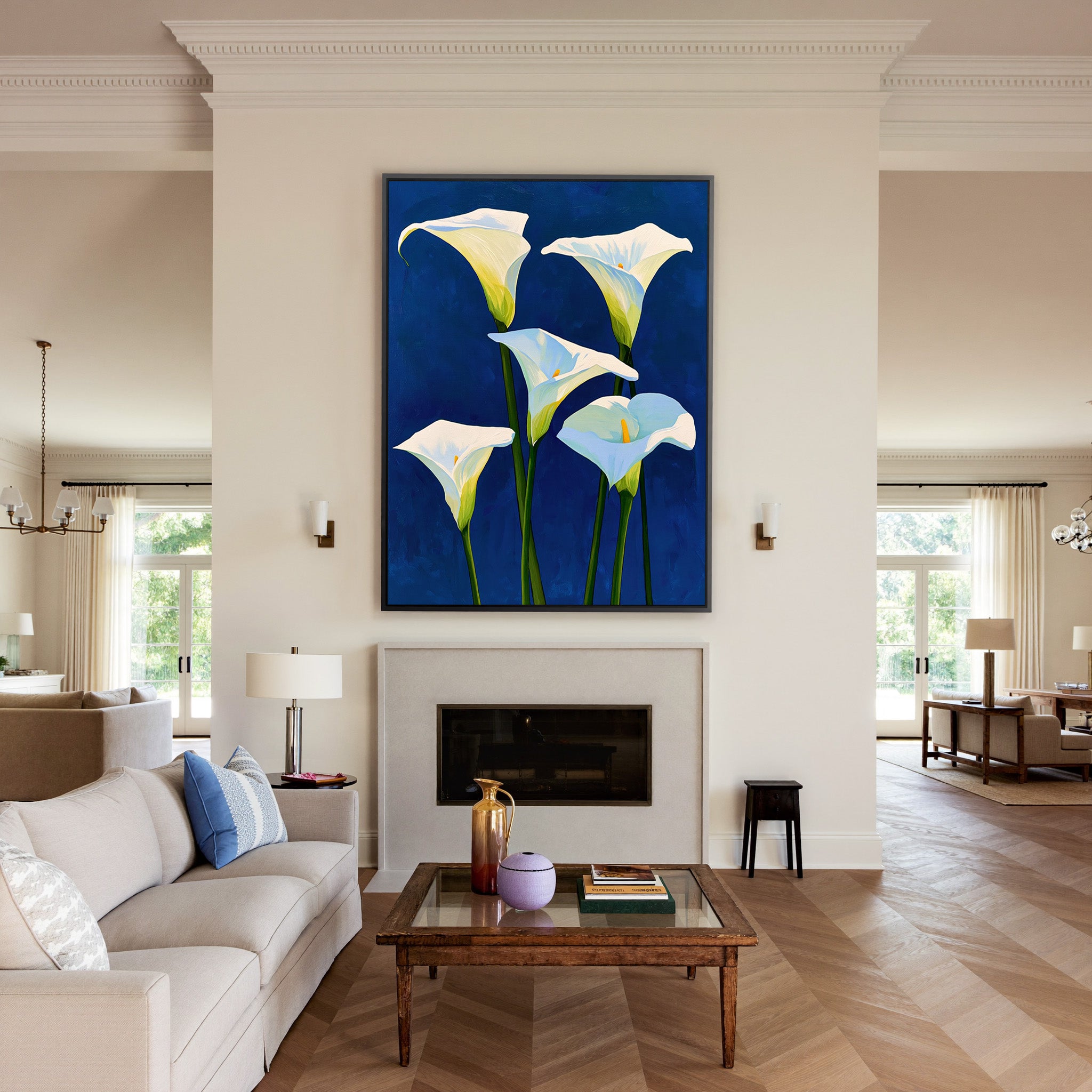 white calla lilies on deep cobalt blue canvas wall art in a black frame above a mantel