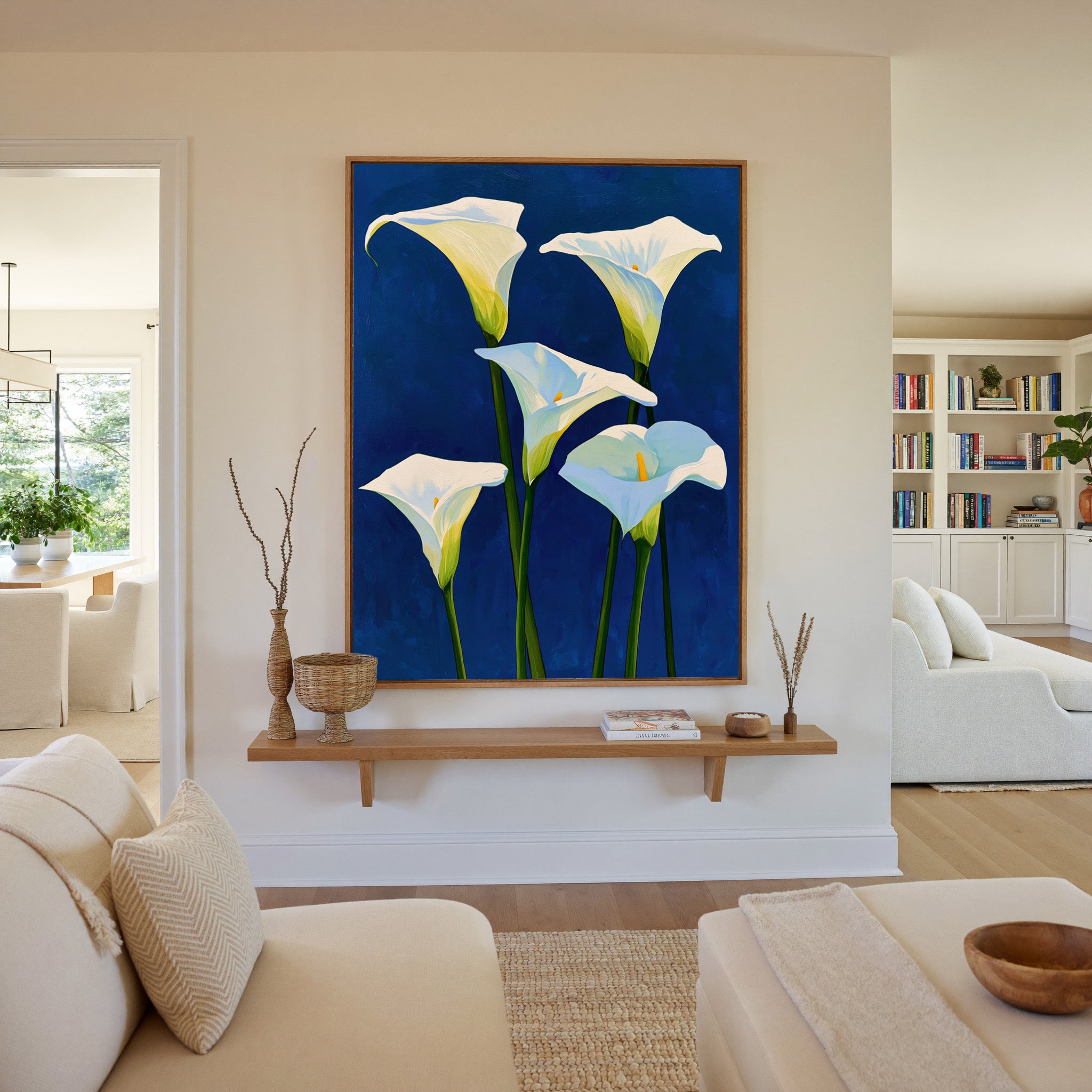 white calla lilies on deep cobalt blue canvas wall art in an oak frame in a living room