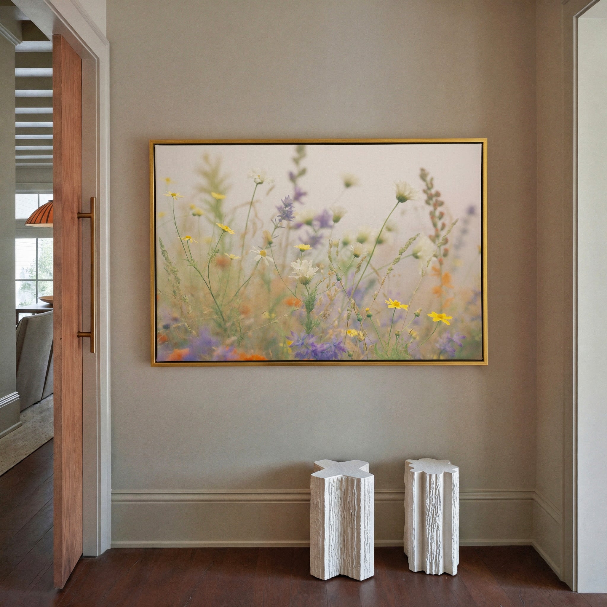 pastel wildflower field with yellow, white, and canvas wall art in a gold frame in a styled room setting