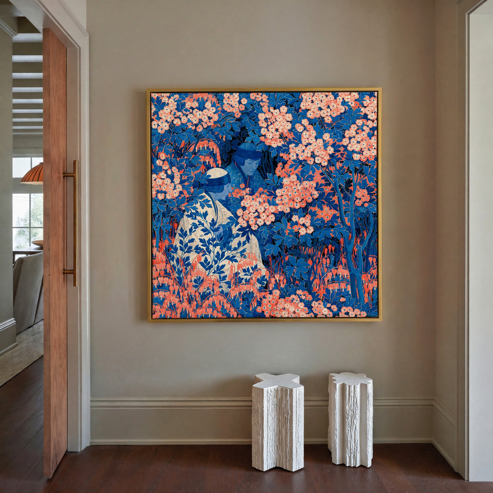 blue and coral garden scene with two seated canvas wall art in a gold frame in a styled room setting