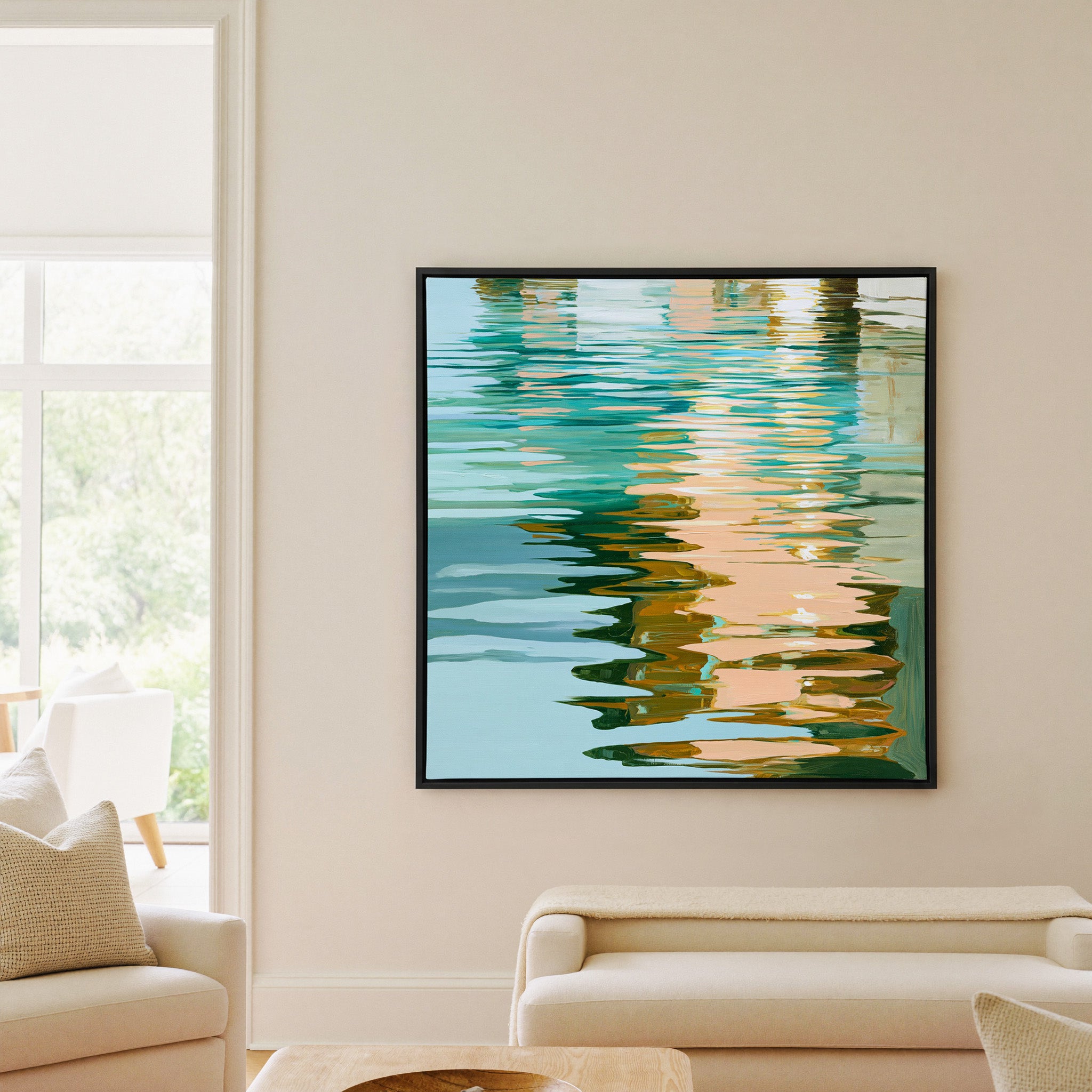 turquoise, peach, and olive abstract with canvas wall art in a black frame in a living room