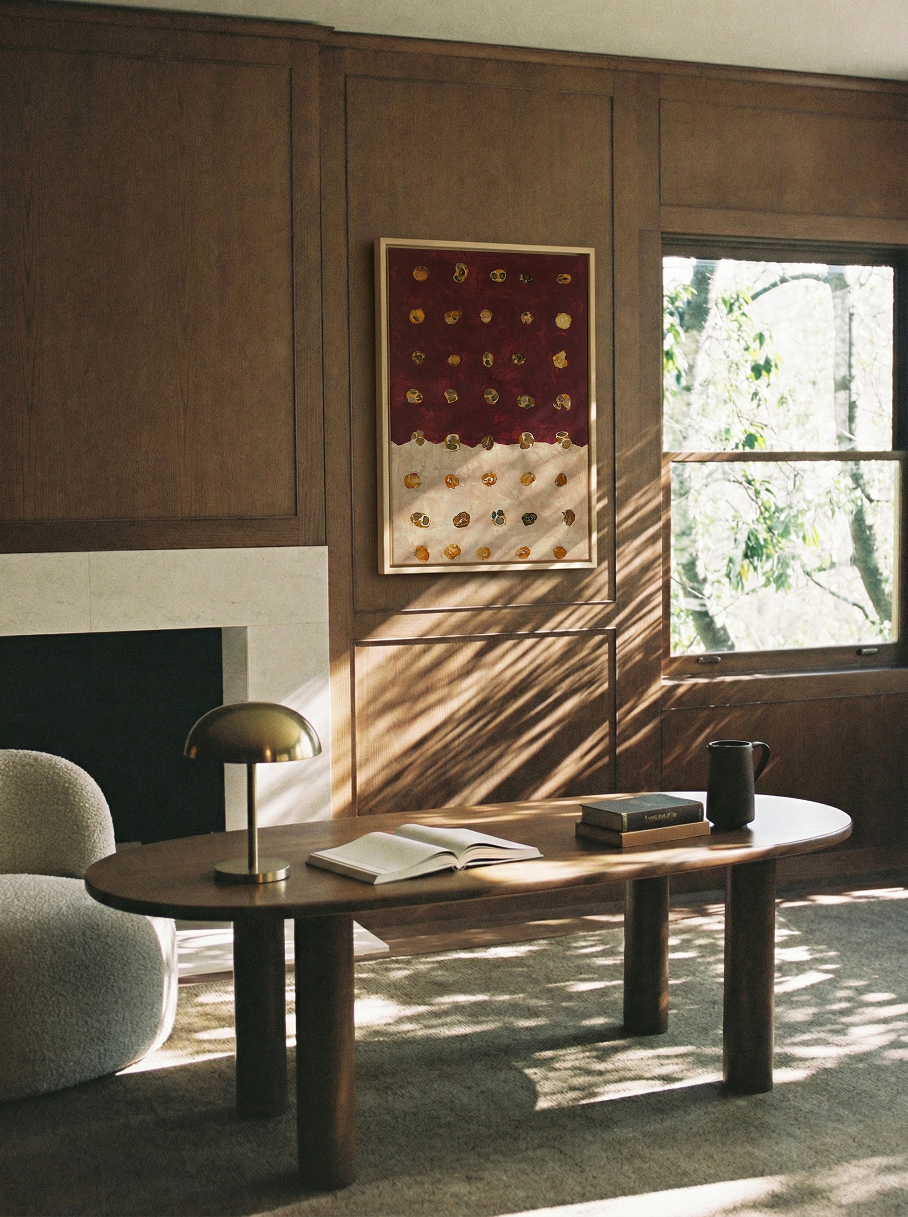 burgundy and cream abstract with scattered canvas wall art in a natural wood frame in a styled room setting