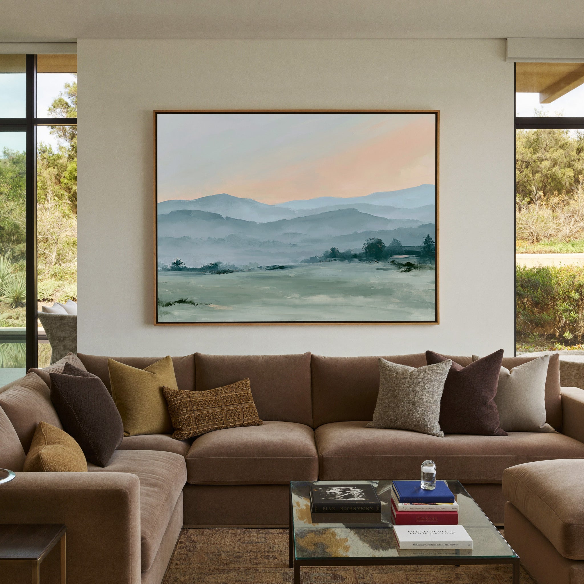 misty blue hills with a peach sky canvas wall art in an oak frame in a styled room setting