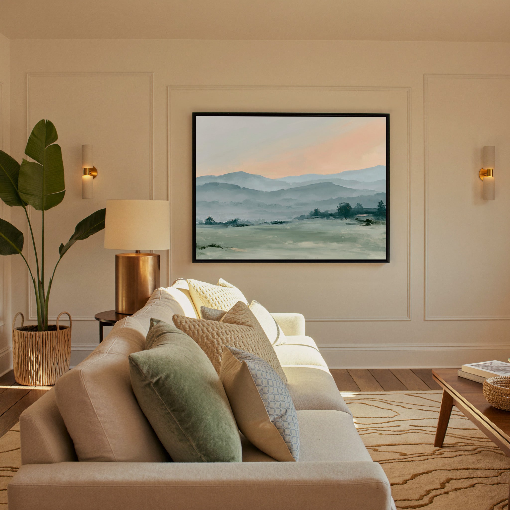 misty blue hills with a peach sky canvas wall art in a black frame in a styled room setting