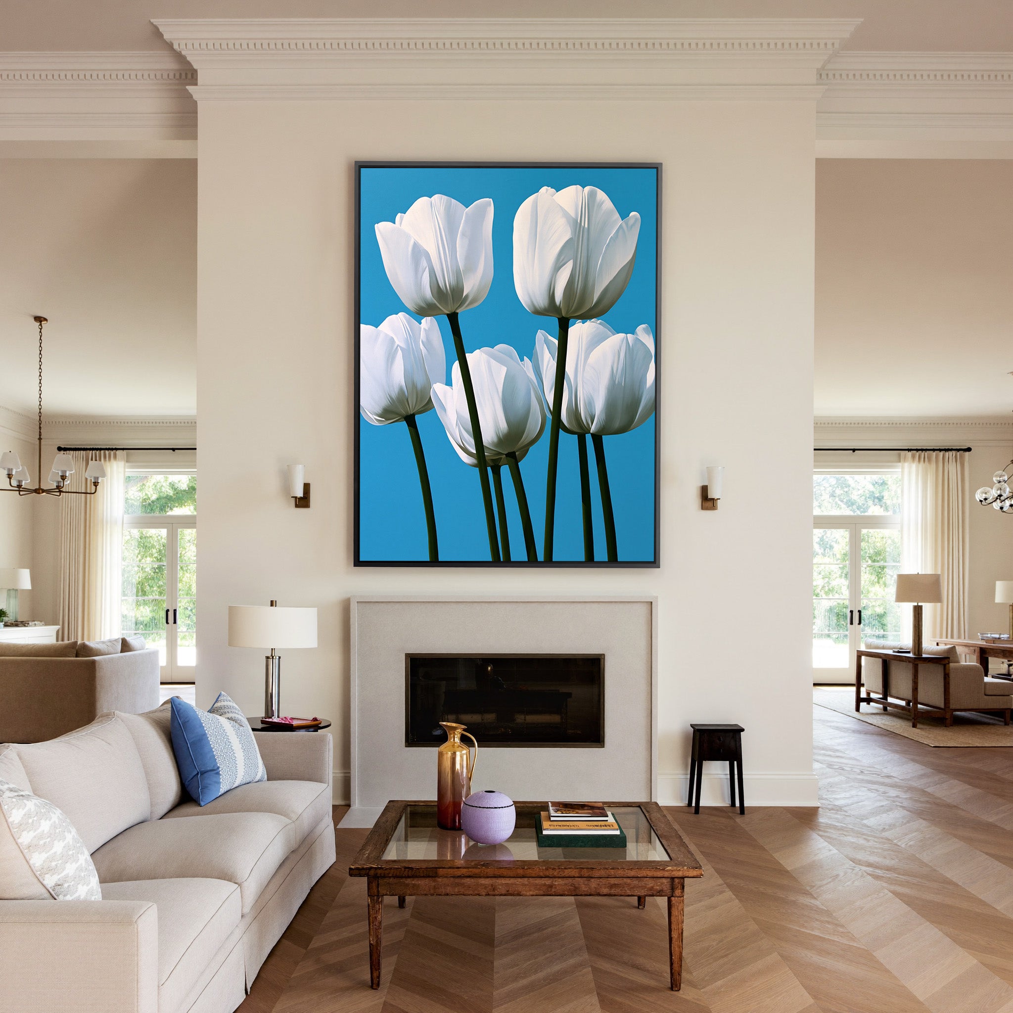 white tulips with deep green stems on a bright canvas wall art in a black frame above a mantel