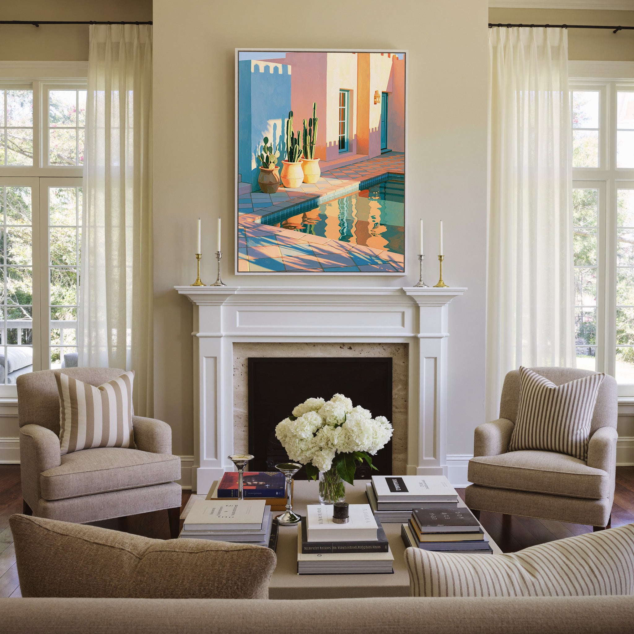 pastel courtyard with cactus pots and pool canvas wall art in a white frame above a mantel