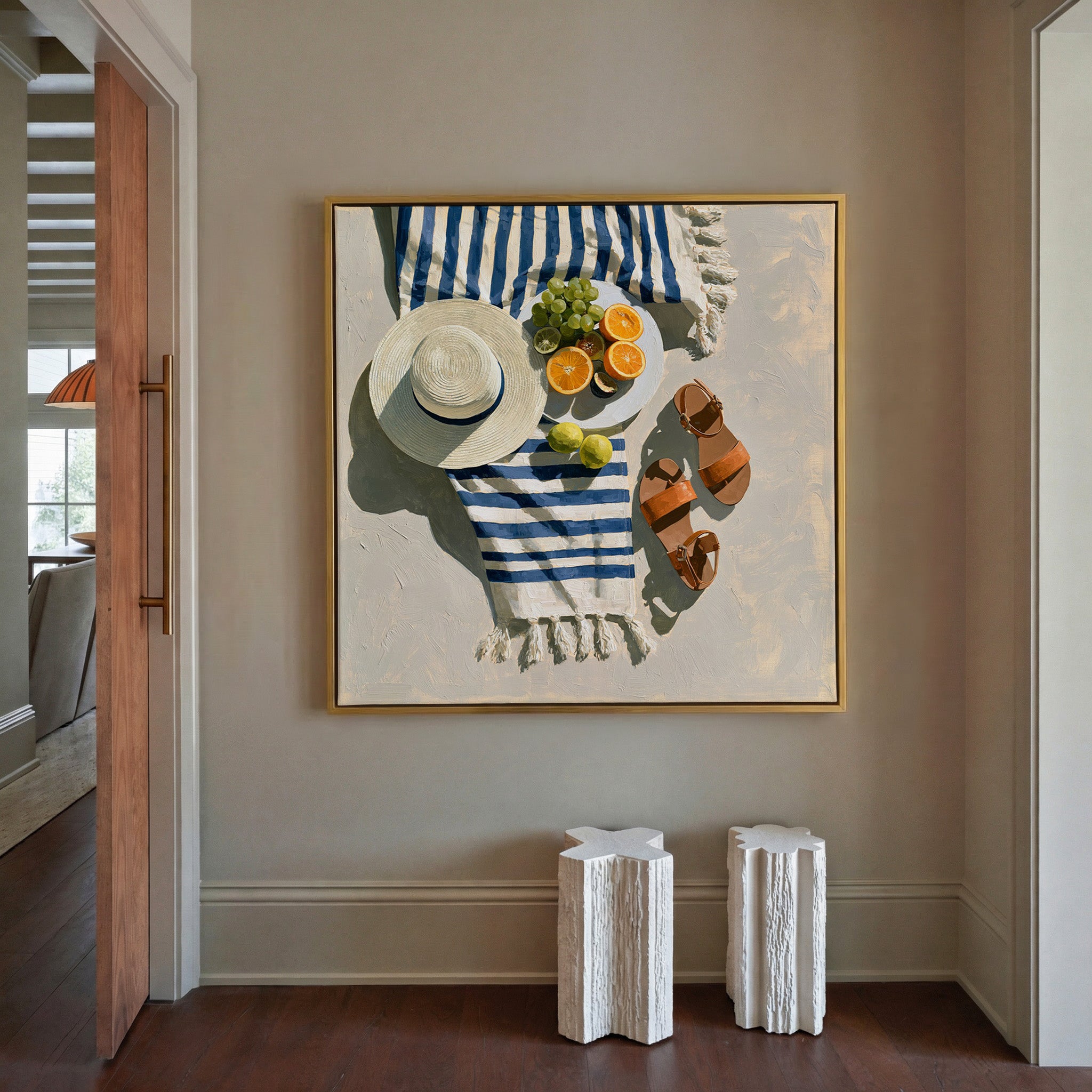 blue striped towel with citrus, hat, and sandals canvas wall art in a gold frame in a styled room setting