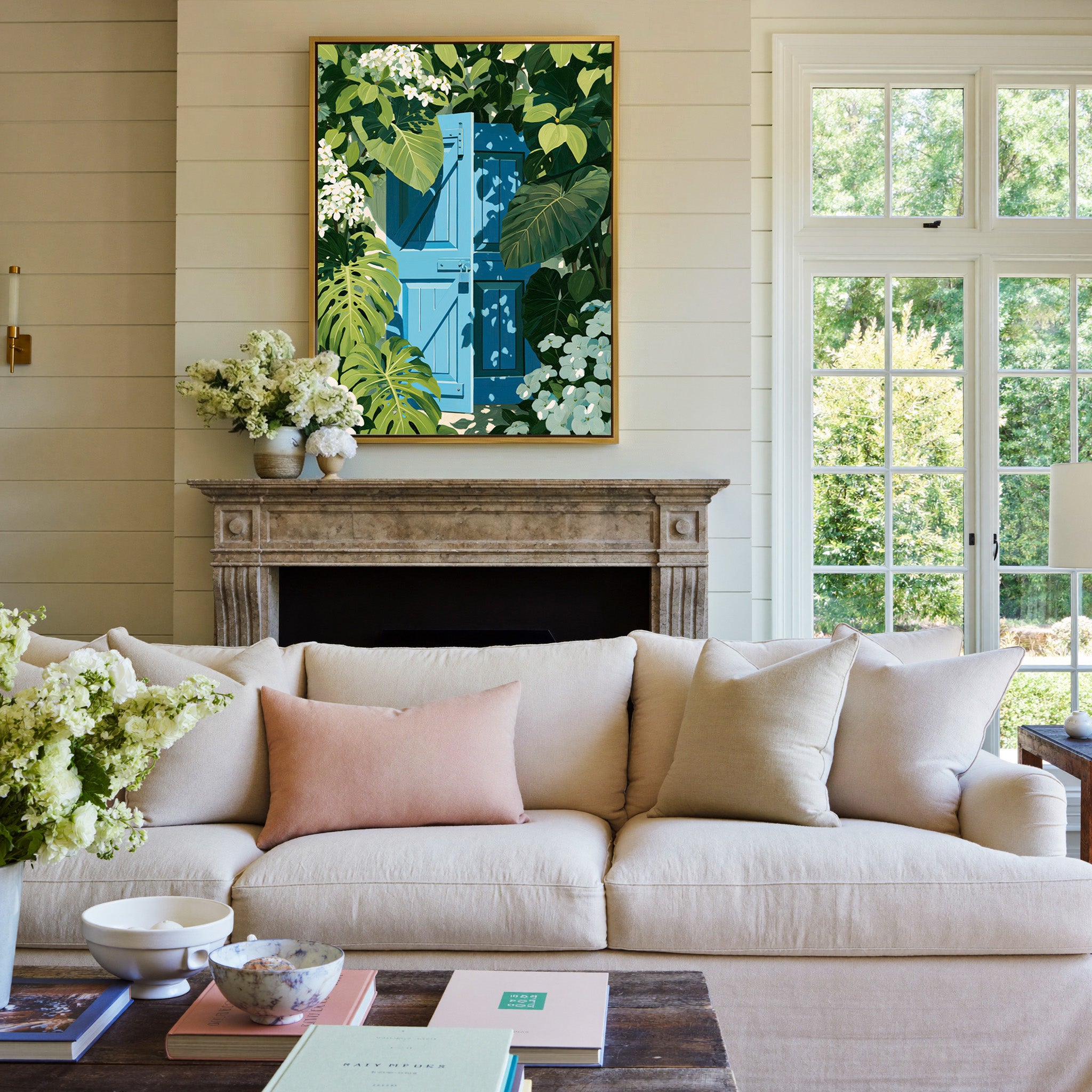 bright blue gate framed by oversized green canvas wall art in a gold frame above a mantel