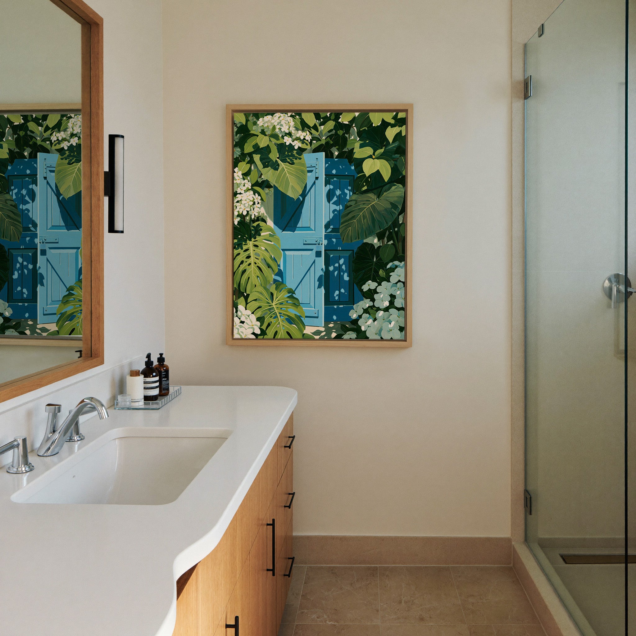 bright blue gate framed by oversized green canvas wall art in a natural wood frame in a styled room setting