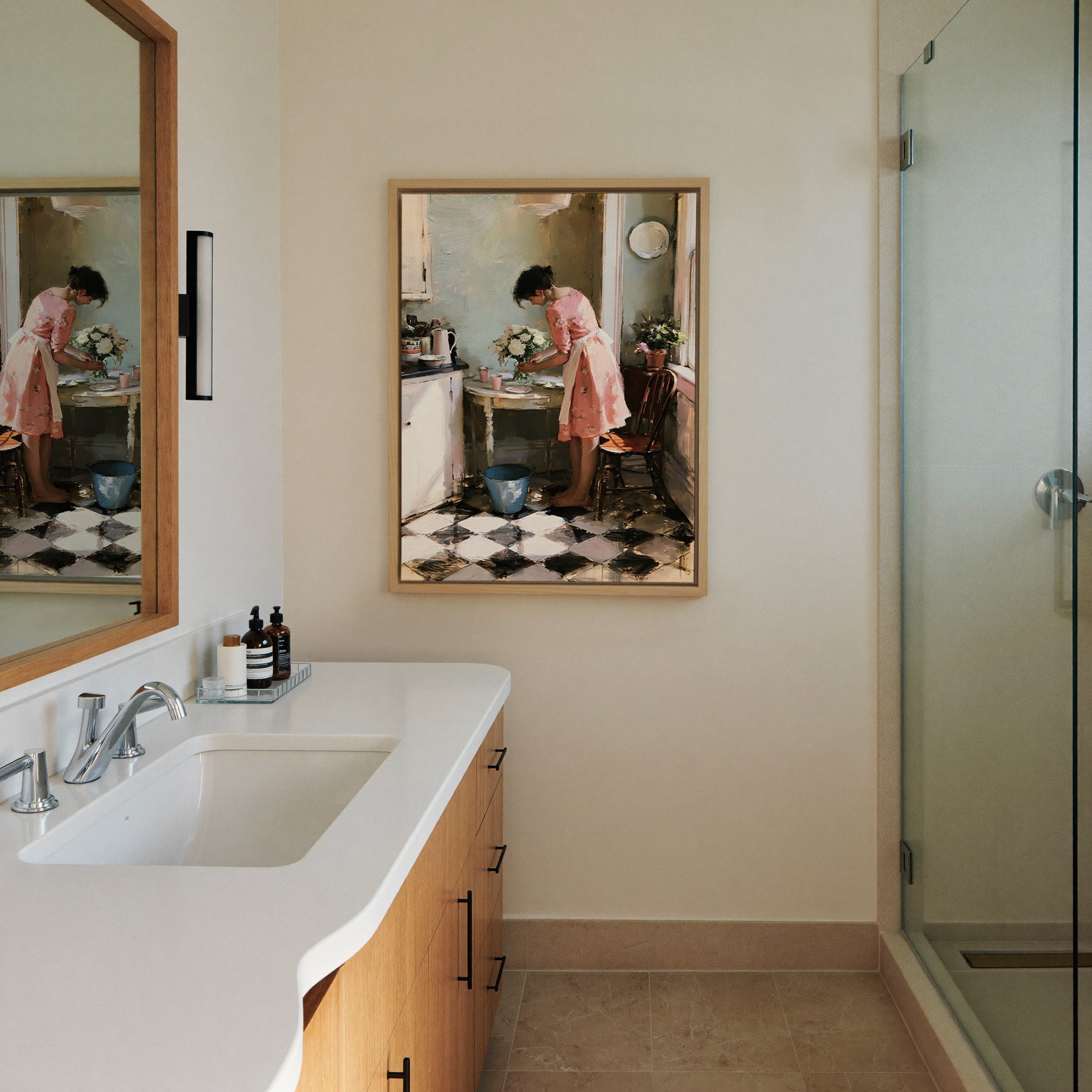 woman in a pink dress arranging white flowers canvas wall art in a natural wood frame in a styled room setting