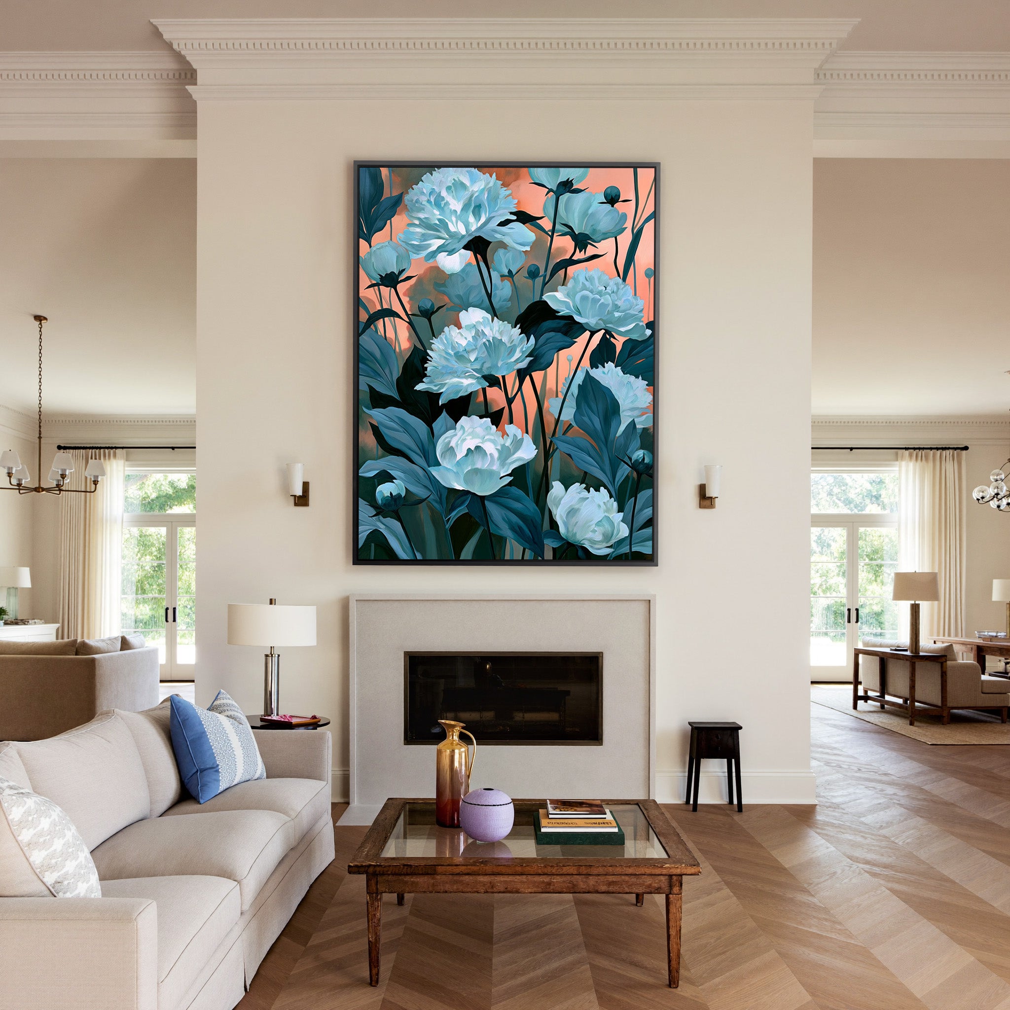 white flowers with teal leaves on a coral dusk canvas wall art in a black frame above a mantel