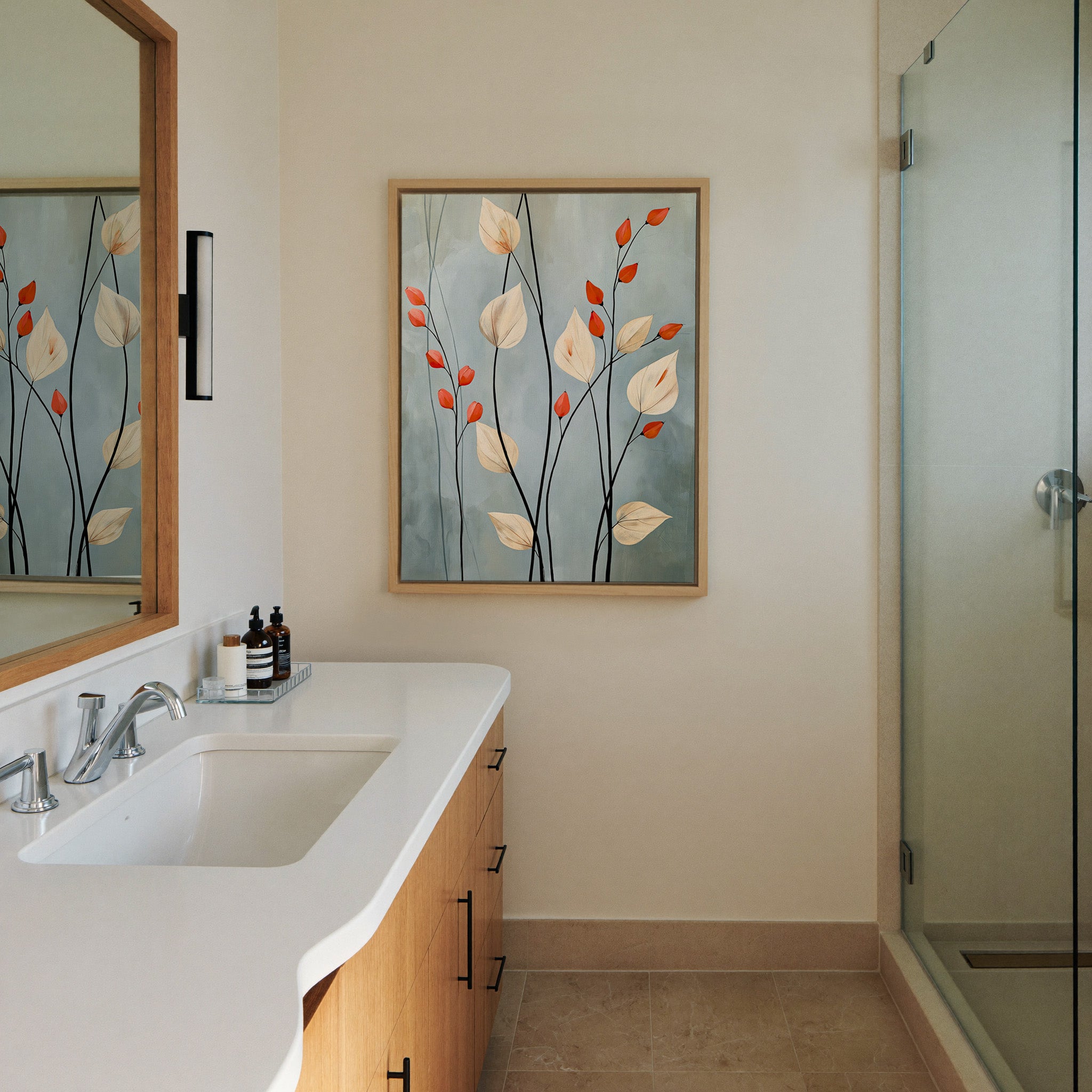 cream leaves and black stems on a blue gray canvas wall art in a natural wood frame in a styled room setting