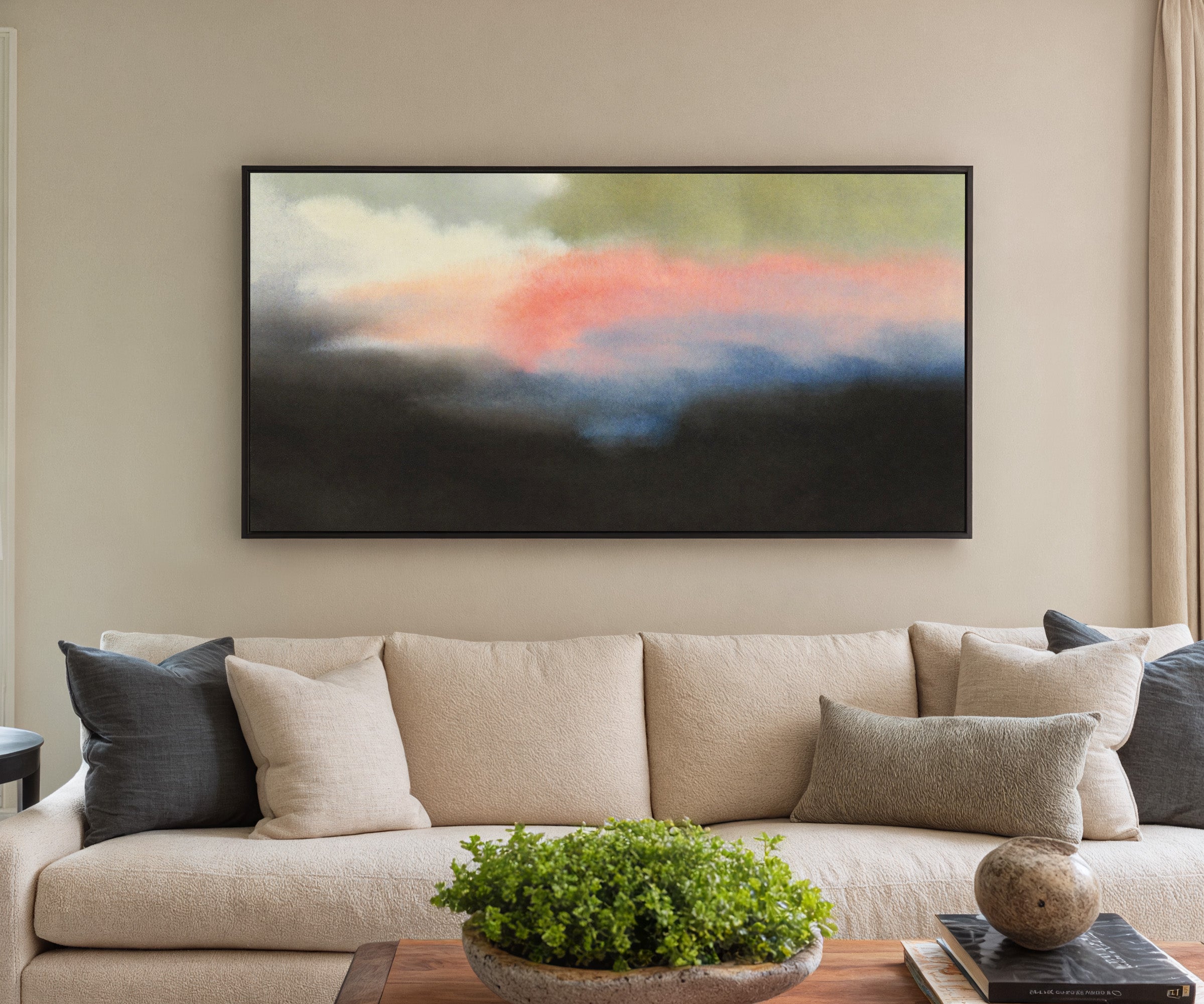 soft pink and blue abstract with dark grounding canvas wall art in a black frame in a styled room setting