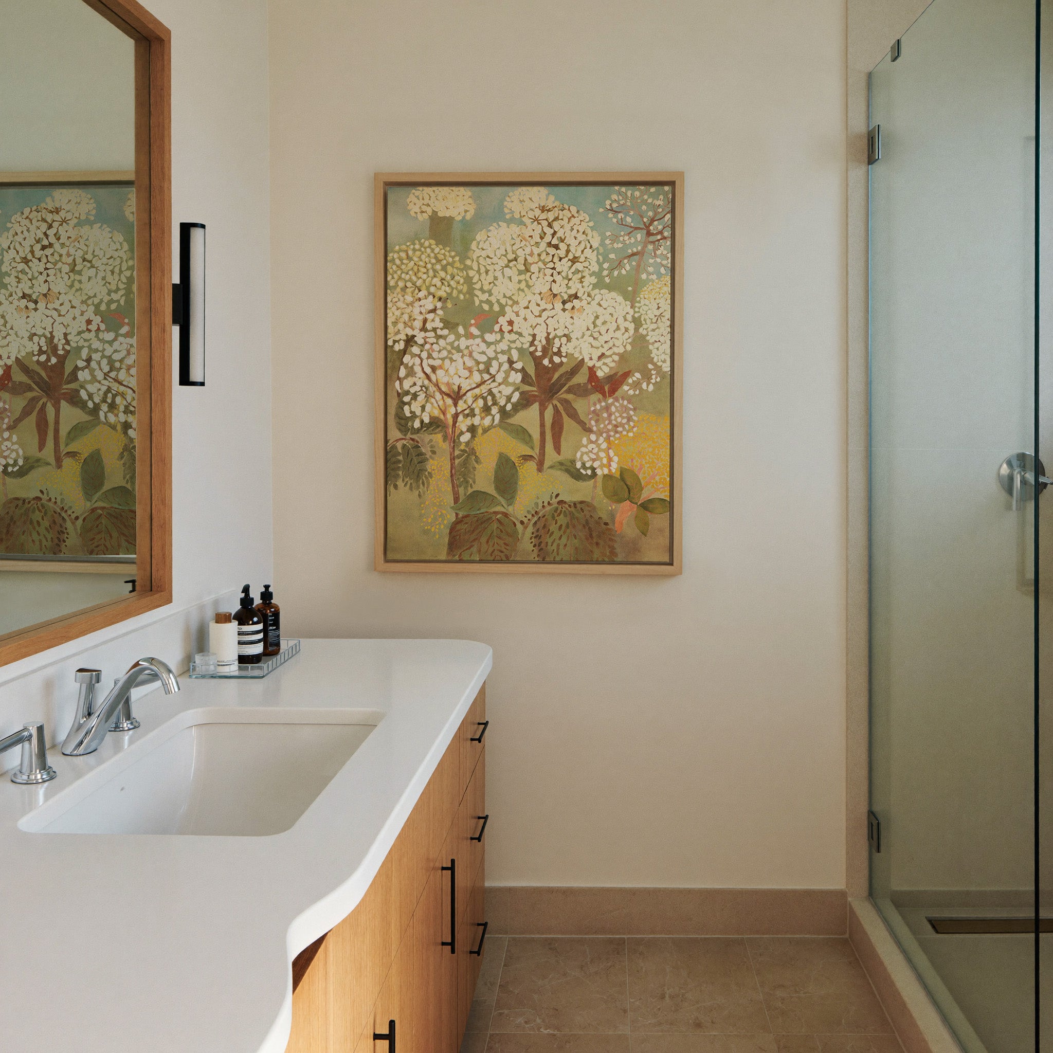 soft floral trees with cream canvas wall art in a natural wood frame in a styled room setting