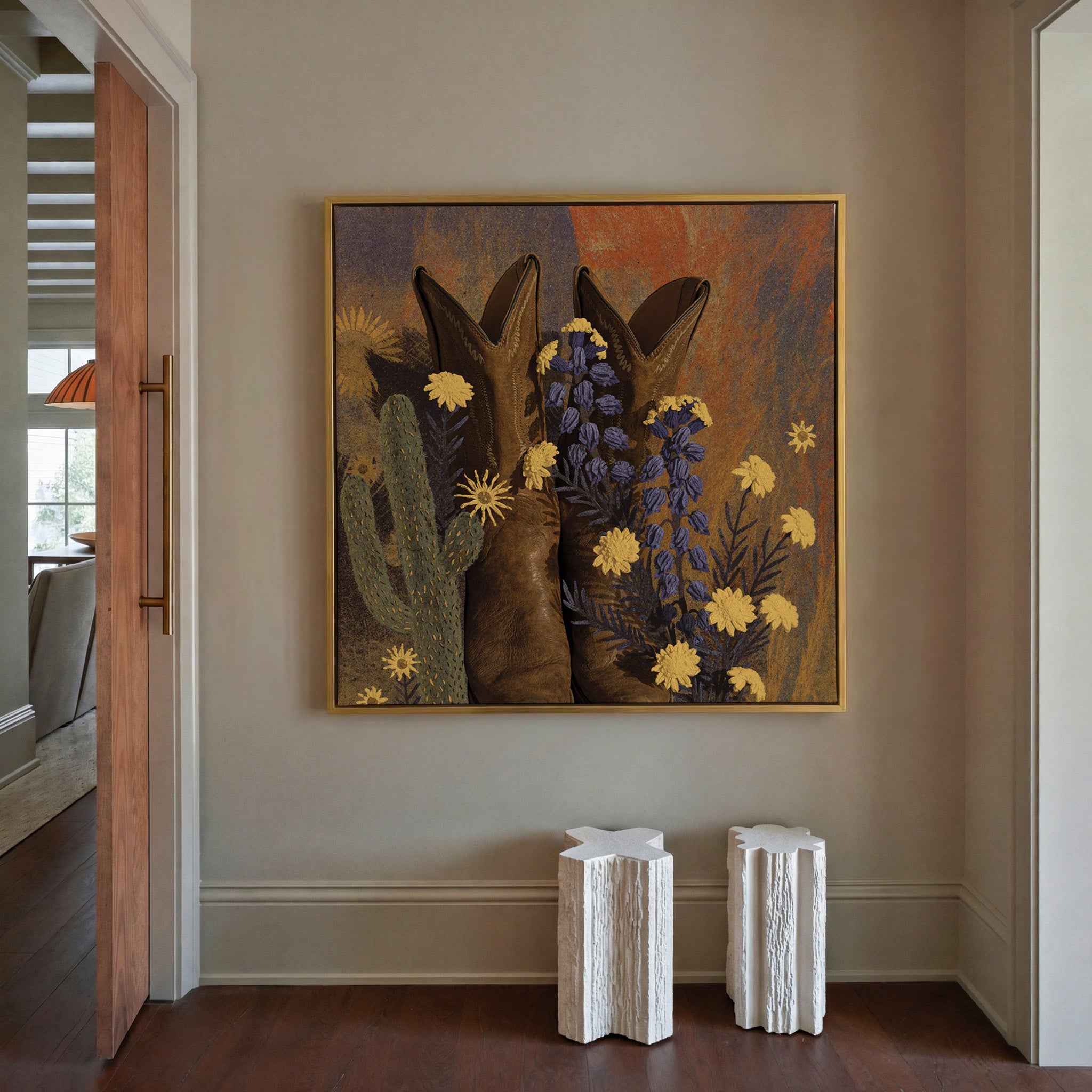 brown boots with yellow and blue wildflowers canvas wall art in a gold frame in a styled room setting