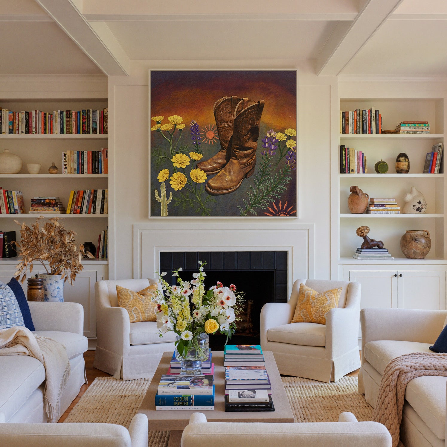 brown boots with yellow and purple wildflowers canvas wall art in a white frame above a fireplace