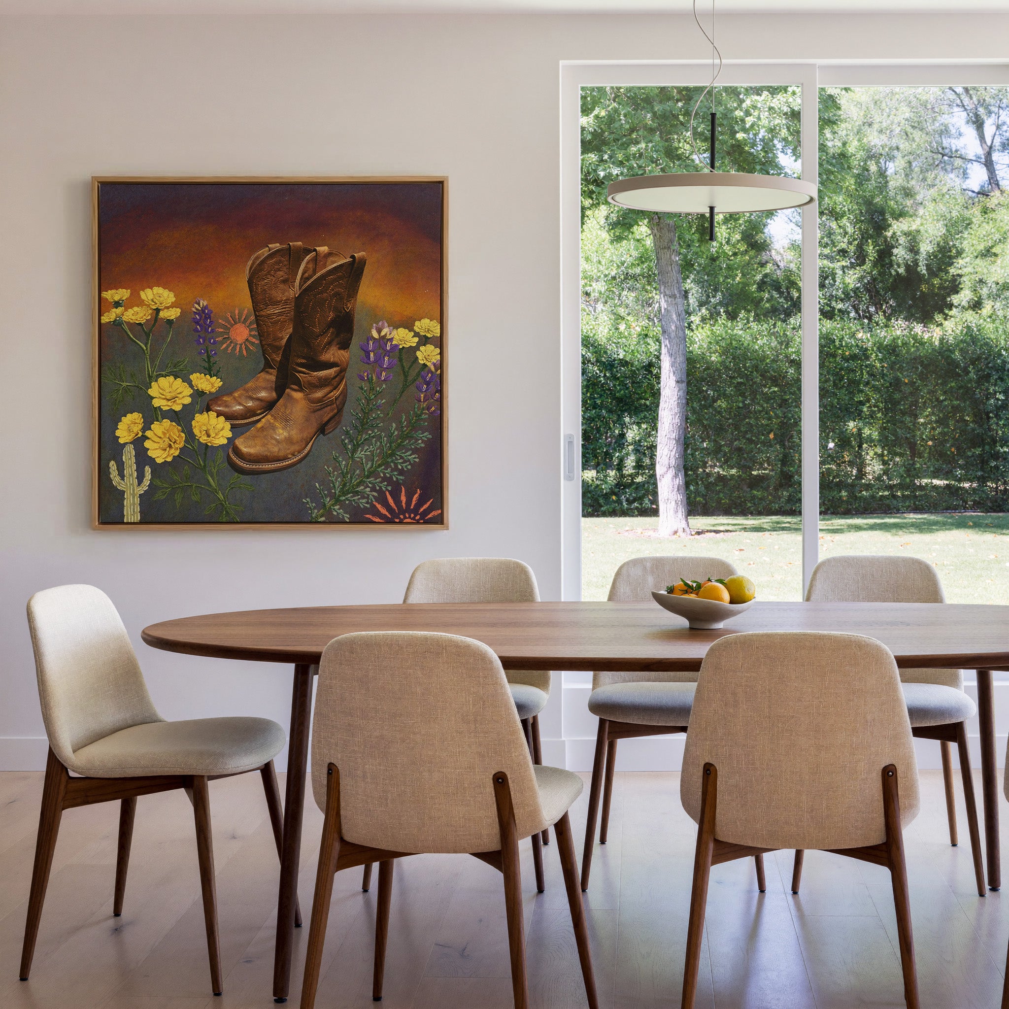 brown boots with yellow and purple wildflowers canvas wall art in an oak frame in a dining room