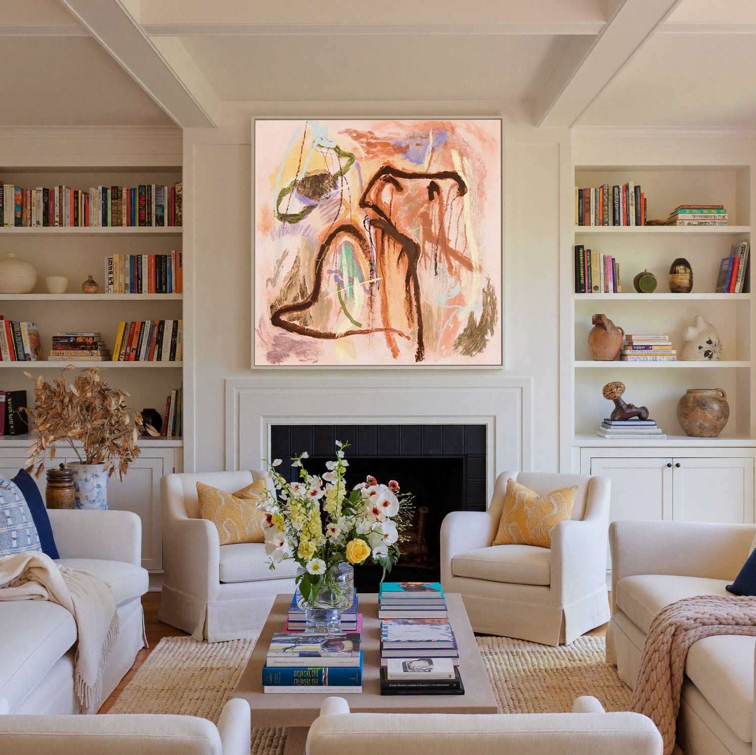 warm peach abstract with dark looping lines and canvas wall art in a white frame above a fireplace
