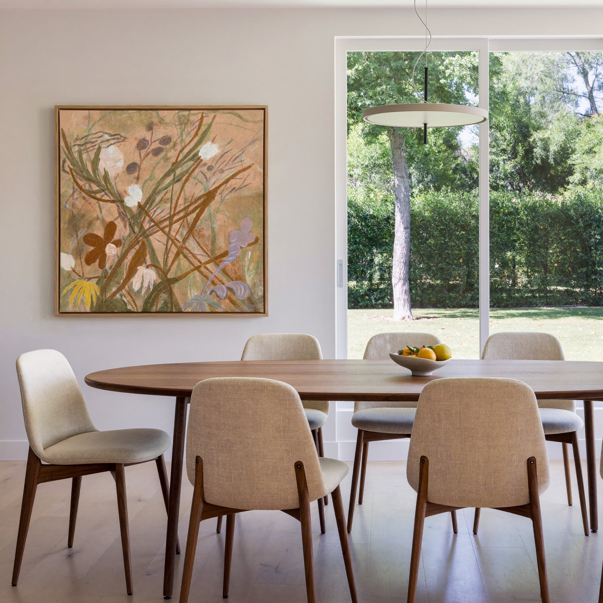 soft botanical meadow with warm tan ground and canvas wall art in an oak frame in a dining room