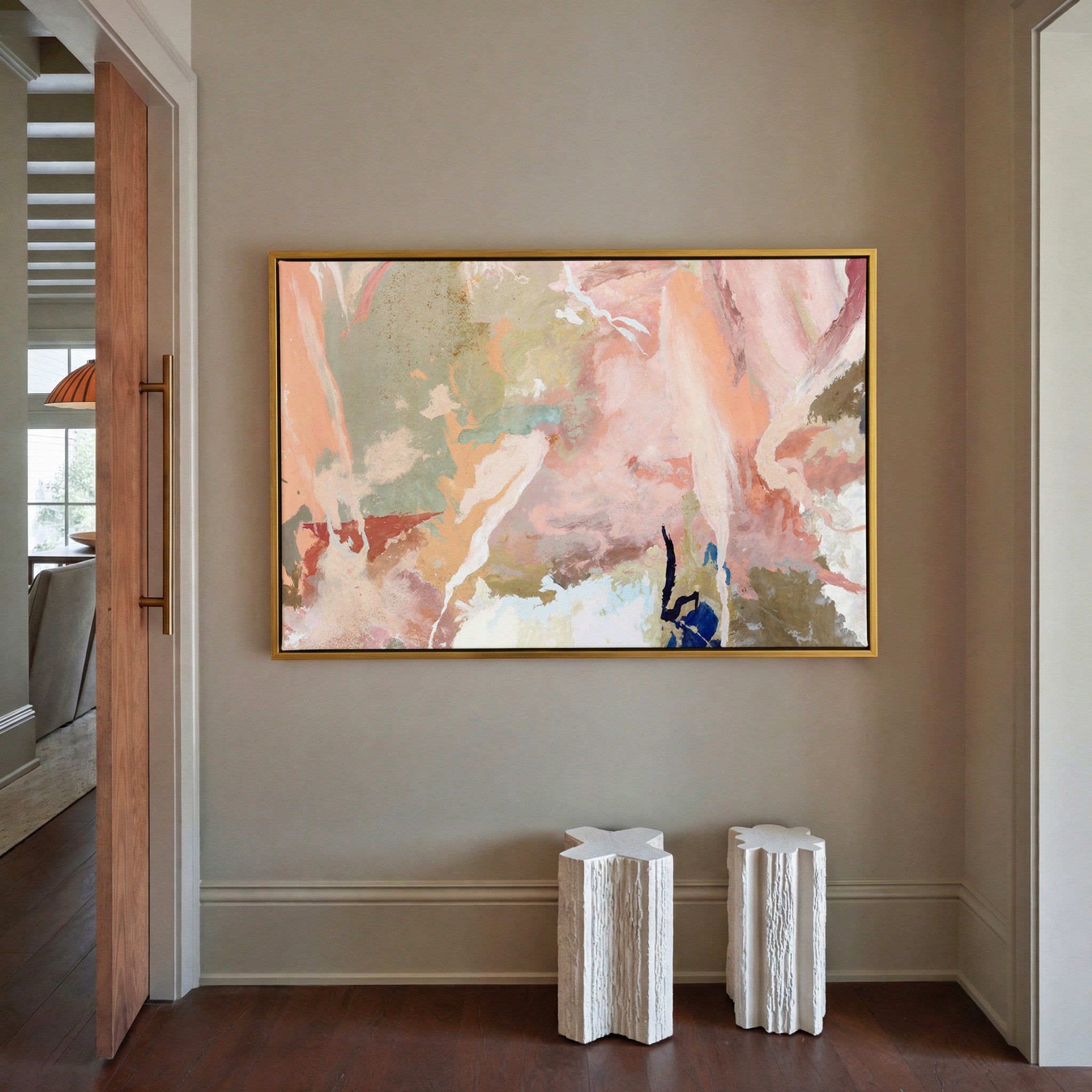 soft peach and sage abstract canvas wall art in a gold frame in a styled room setting