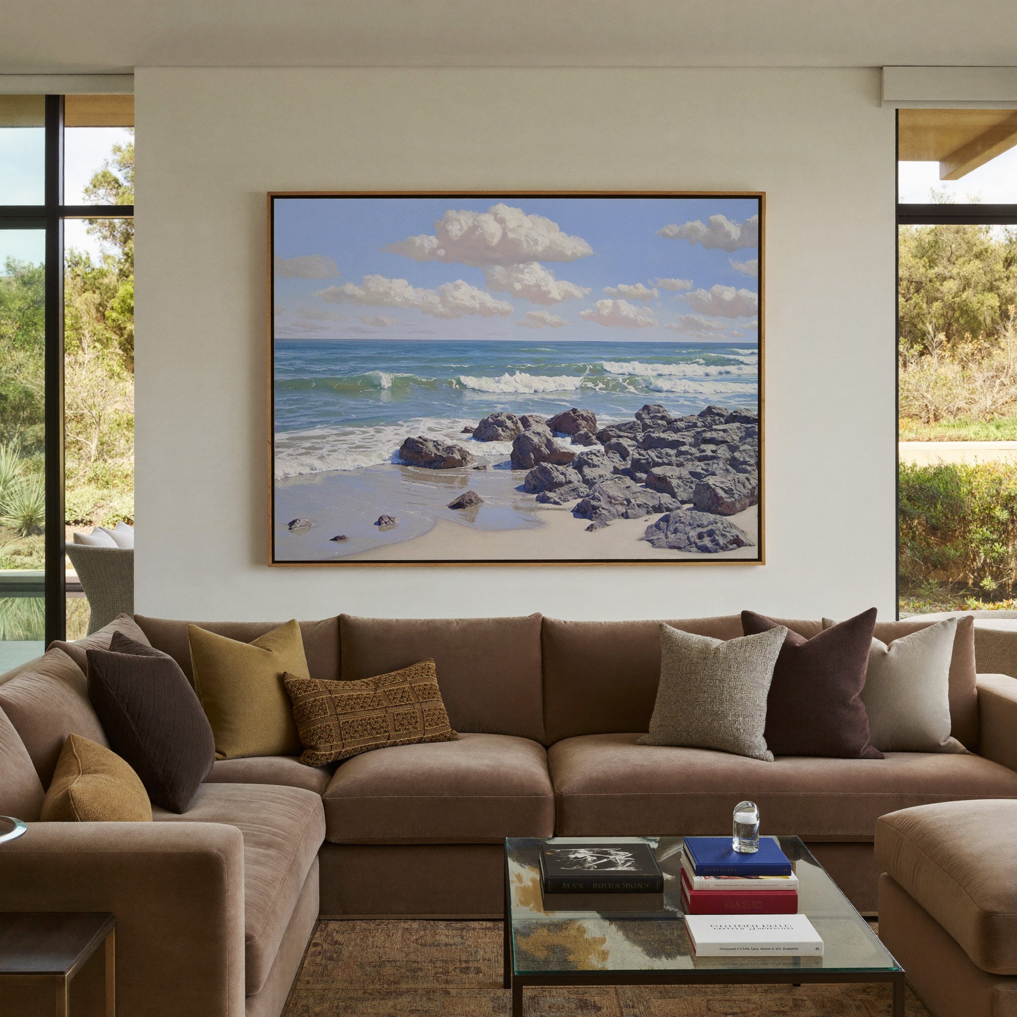 rocky shore with rolling surf and soft cloud canvas wall art in an oak frame in a styled room setting