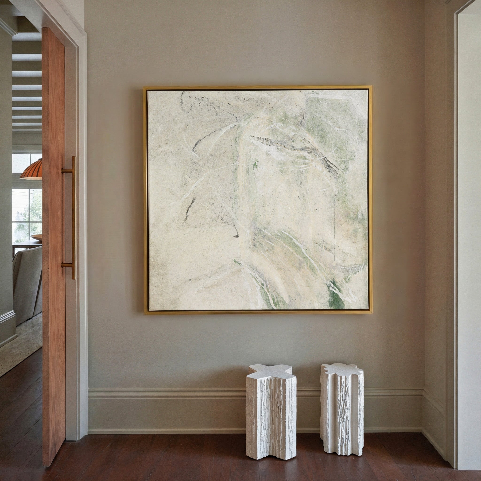 soft cream abstract with pale green sweeps and canvas wall art in a gold frame in a styled room setting