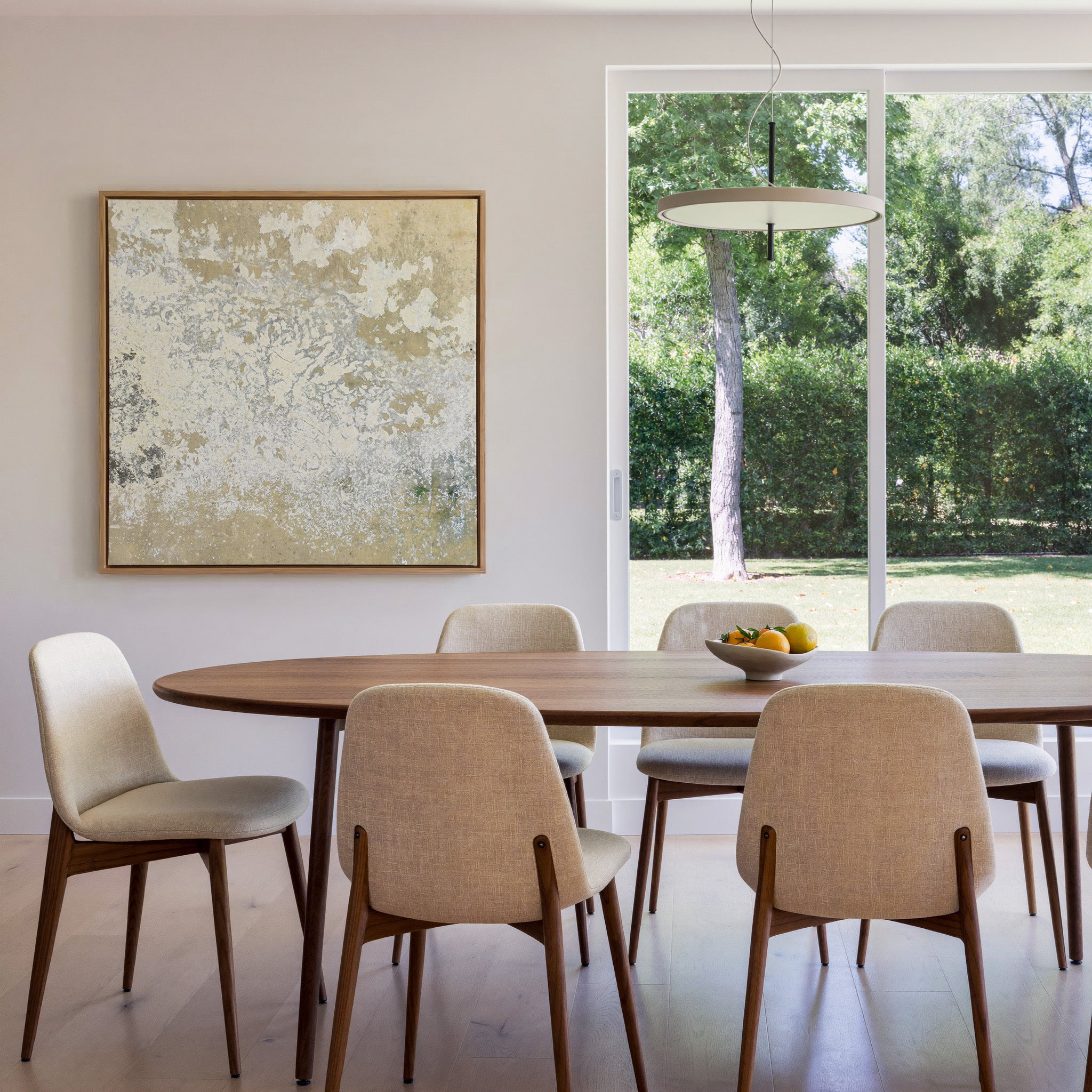 weathered cream and taupe abstract canvas wall art in an oak frame in a dining room