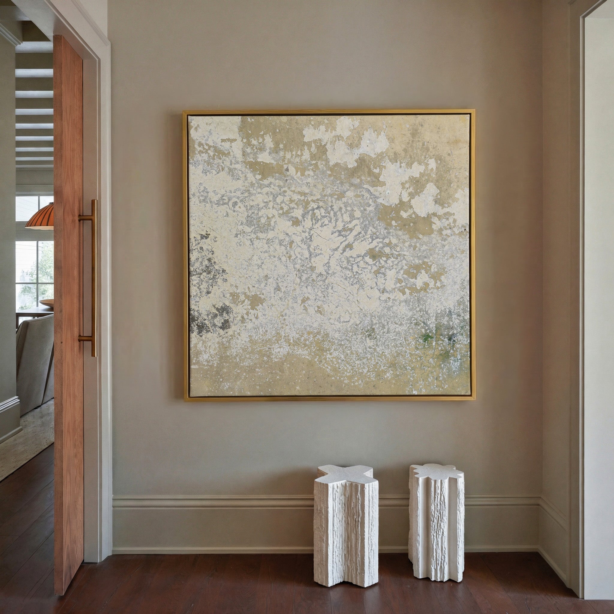 weathered cream and taupe abstract canvas wall art in a gold frame in a styled room setting