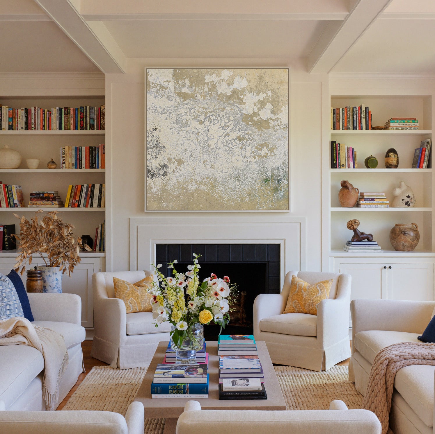 weathered cream and taupe abstract canvas wall art in a white frame above a fireplace