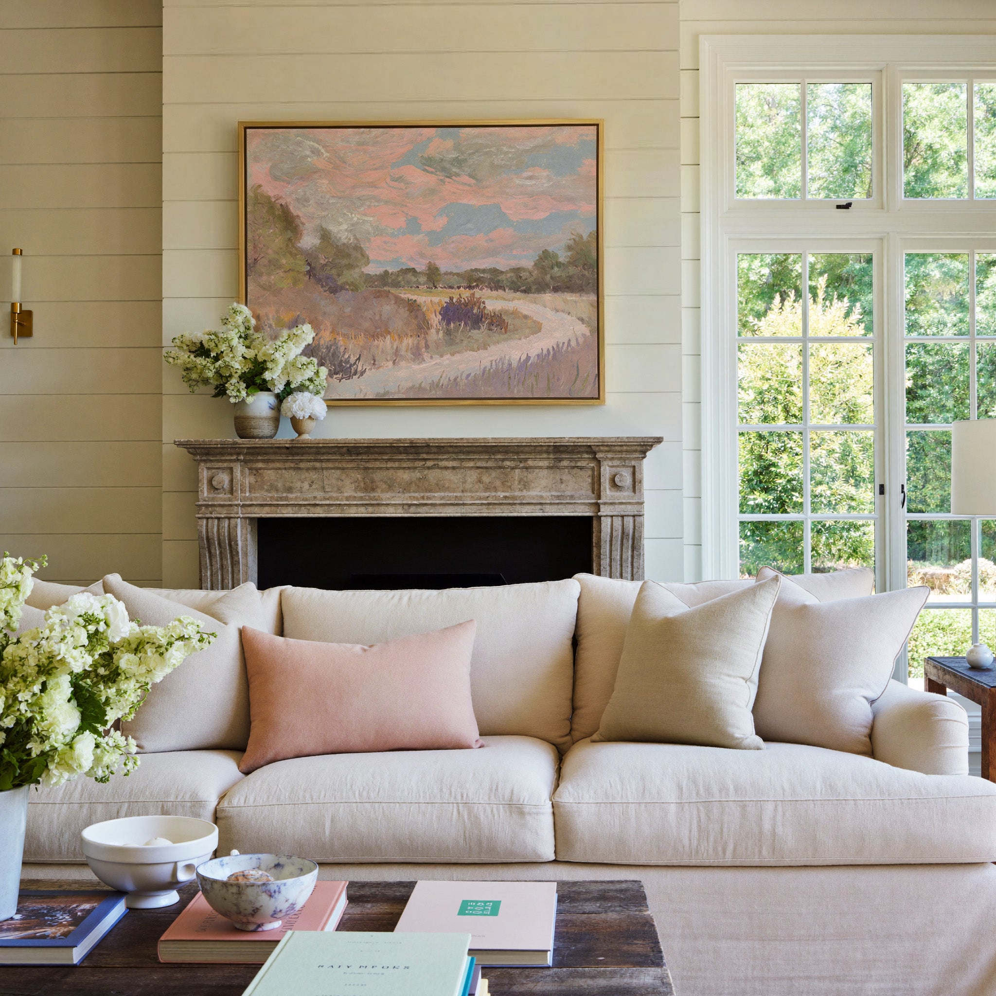 pastel meadow path with pink sky and lavender canvas wall art in a gold frame above a mantel