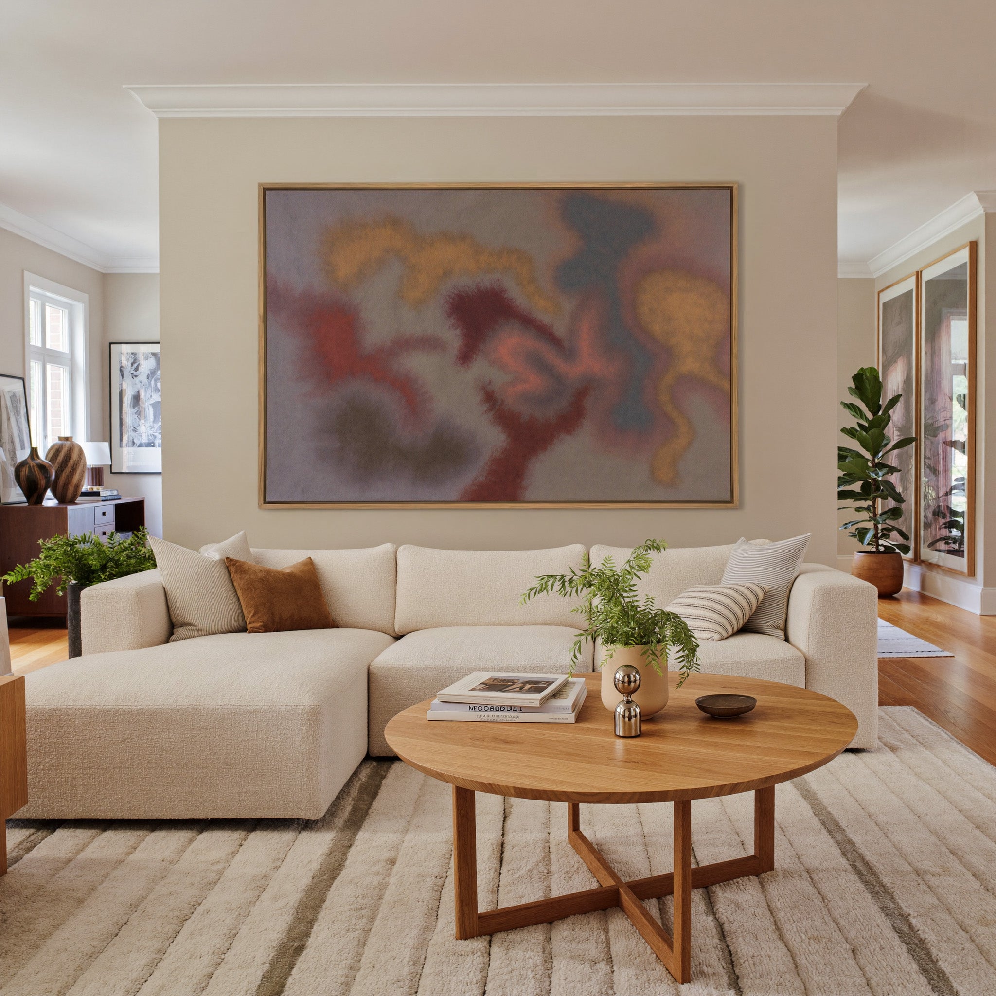 soft rust, gold, and slate abstract canvas wall art in an oak frame in a living room