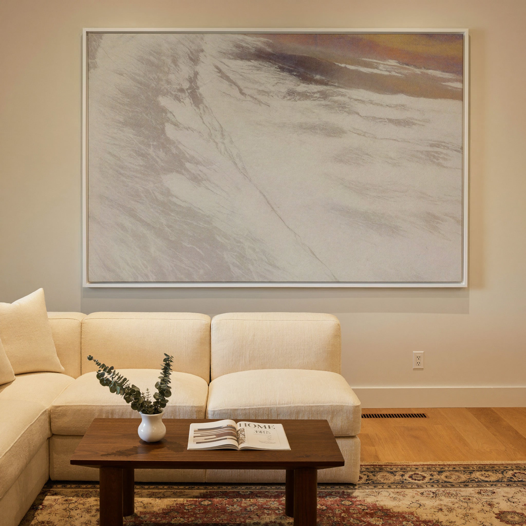 warm beige abstract with sweeping diagonal canvas wall art in a white frame in a styled room setting